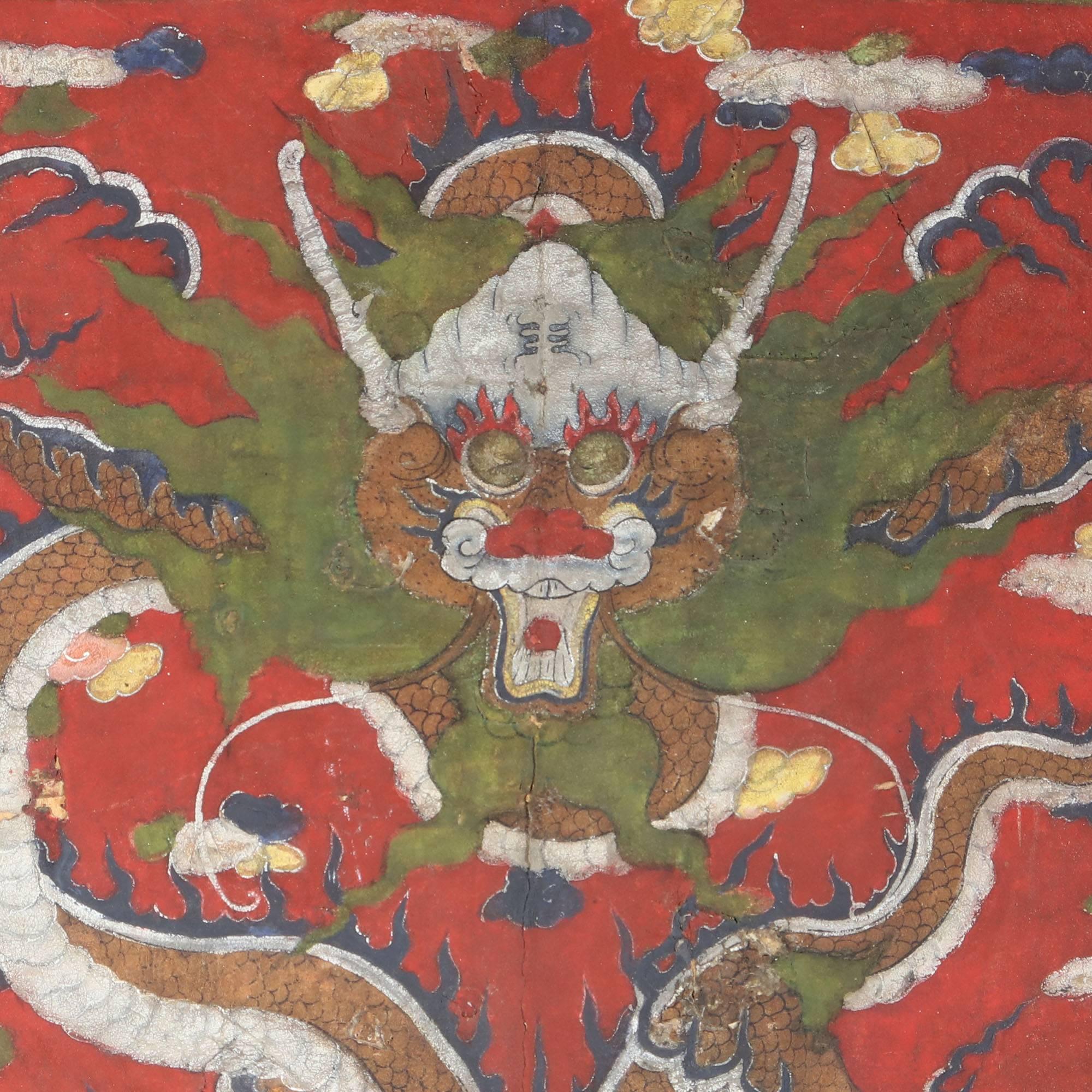 An unusual Tibetan vellum panel depicting a flying dragon set on a red ground amid auspicious symbols.

Tibet circa 1800

Measures: Height 28 inches width 44 inches.