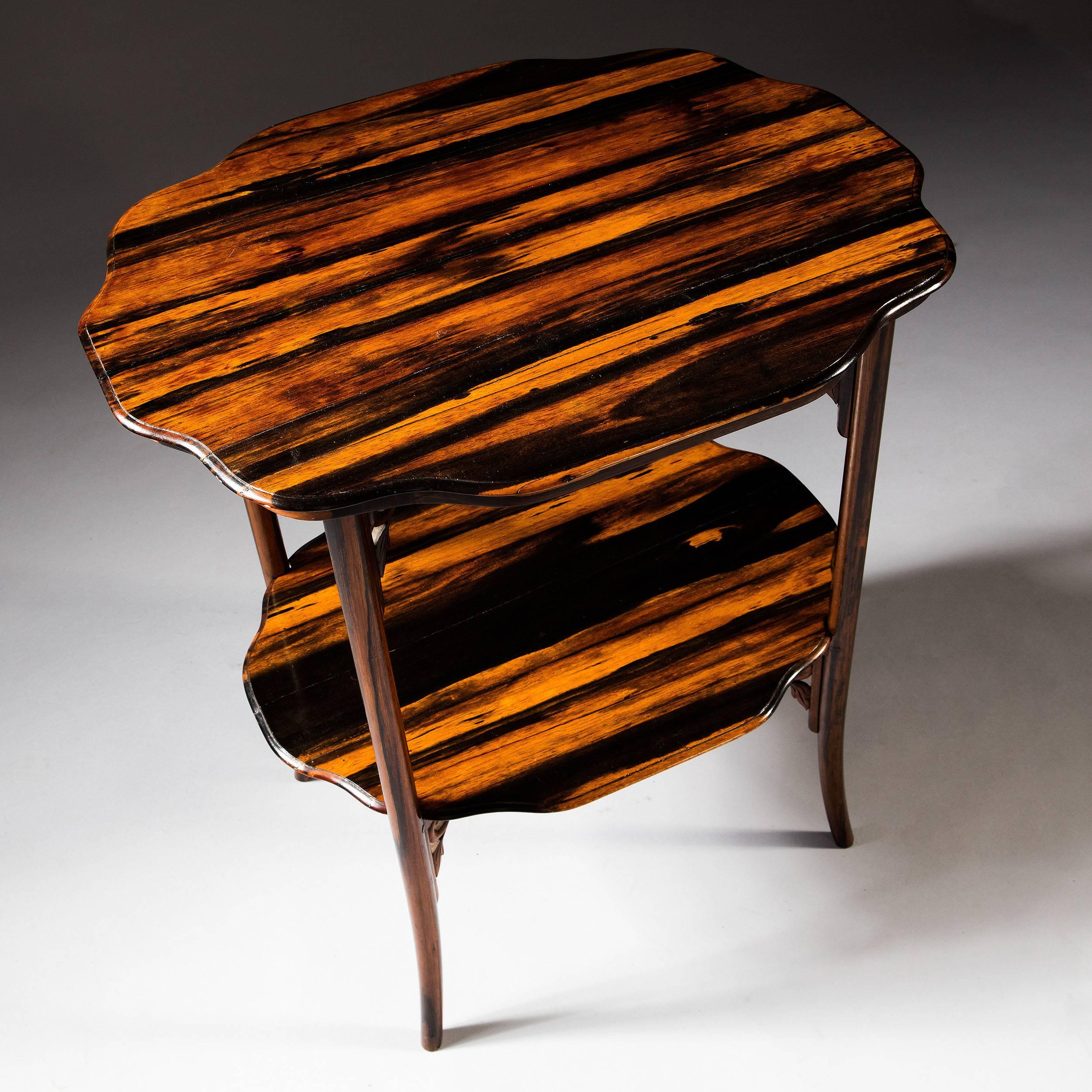 A very unusual Indian export 19th century calamander wood table the scalloped shaped top supported on a folding Stand with legs of Chinese design. The lower level also removable. 

This table was almost certainly made in India for the Asian