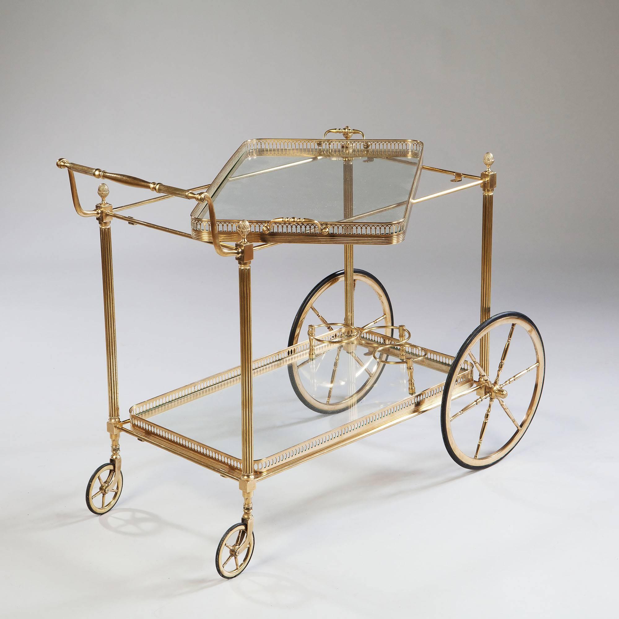 A fine quality early 20th century polished brass and glass two tier drinks trolley, both trays removable and the upper one with handles. This trolley with larger wheels at the front.