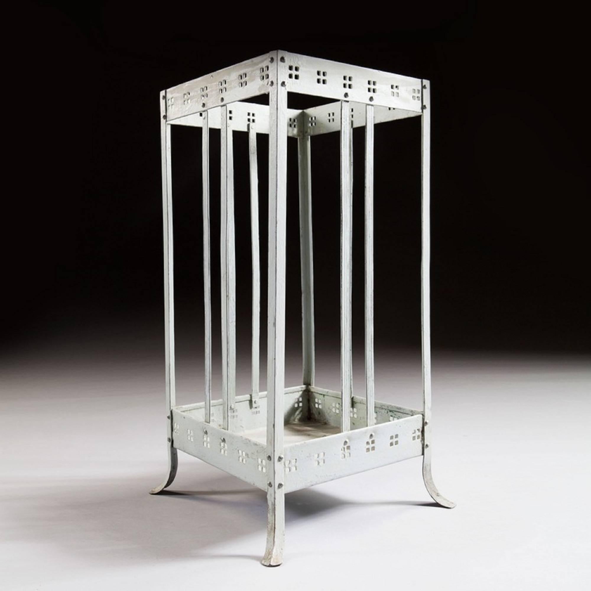 A Viennese Secessionist grey painted metal stick stand in the manner of Joseph Hoffman. The top and base each marked by a pierced band decorated of square groups of four squares. The sides and corners have delicate incised stringing and terminate in