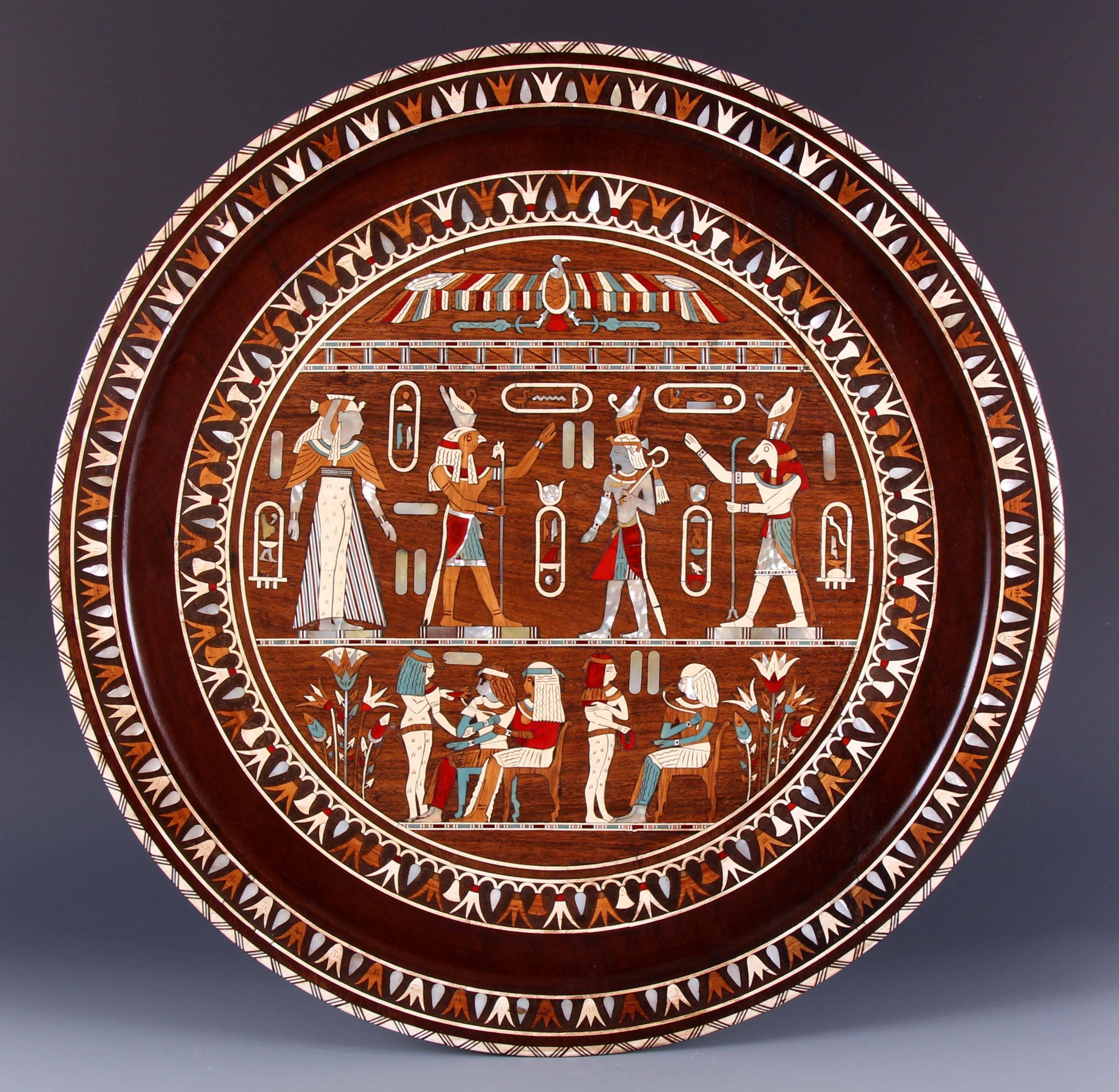 Magnificent 19th century grand tour Egyptian revival inlaid plaque, charger or tray. Profusely inlaid with mother-of-pearl and bone in finely detailed polychromed hieroglyphics. 

It is in excellent condition for its age.

Throughout the late 18th