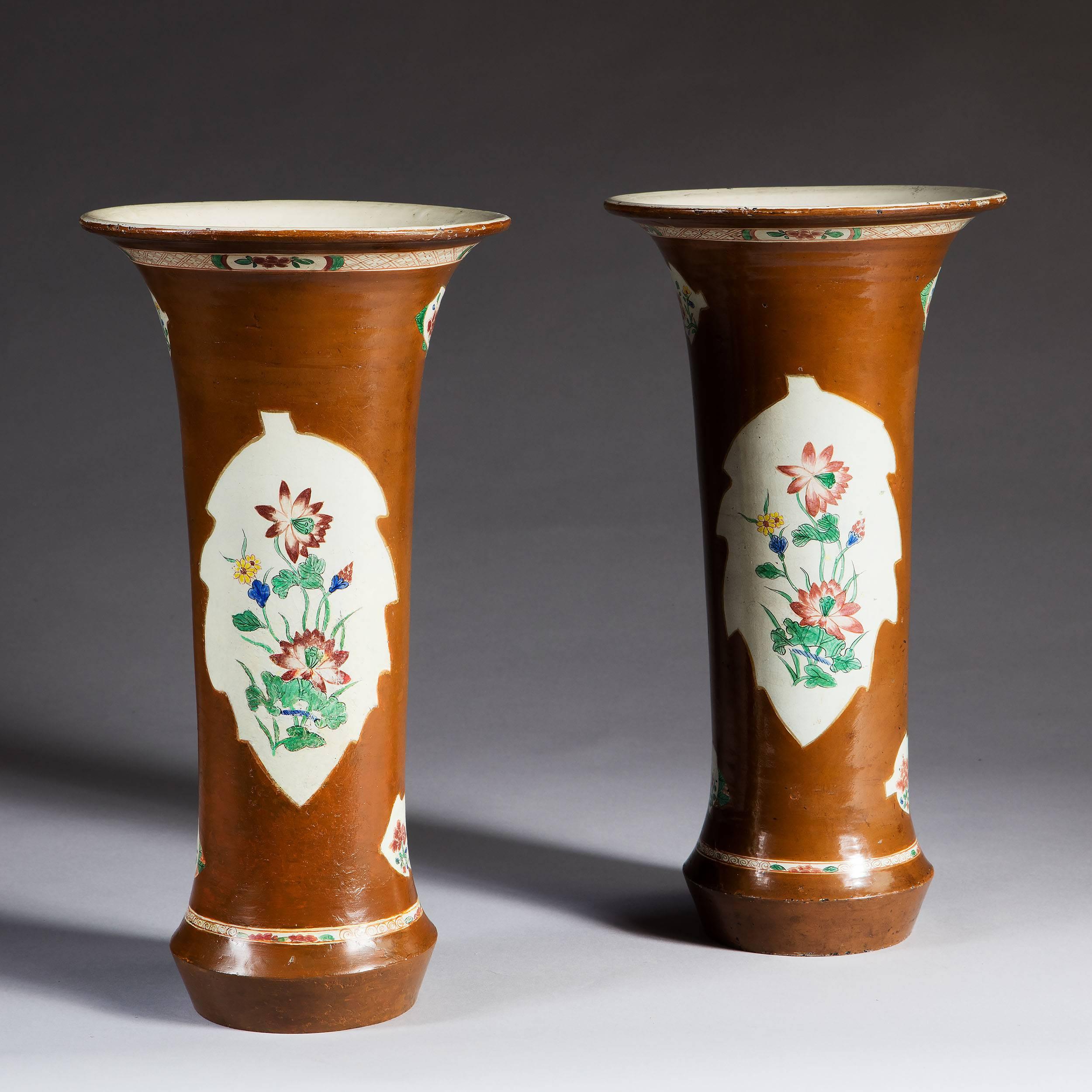 Probably Berlin, early 18th century.

A very unusual and rare pair of early 18th century Batavia style brown Japanned trumpet vases, probably Berlin pottery. The vases are japanned in the fashionable Batavia brown glaze palette with hand-painted