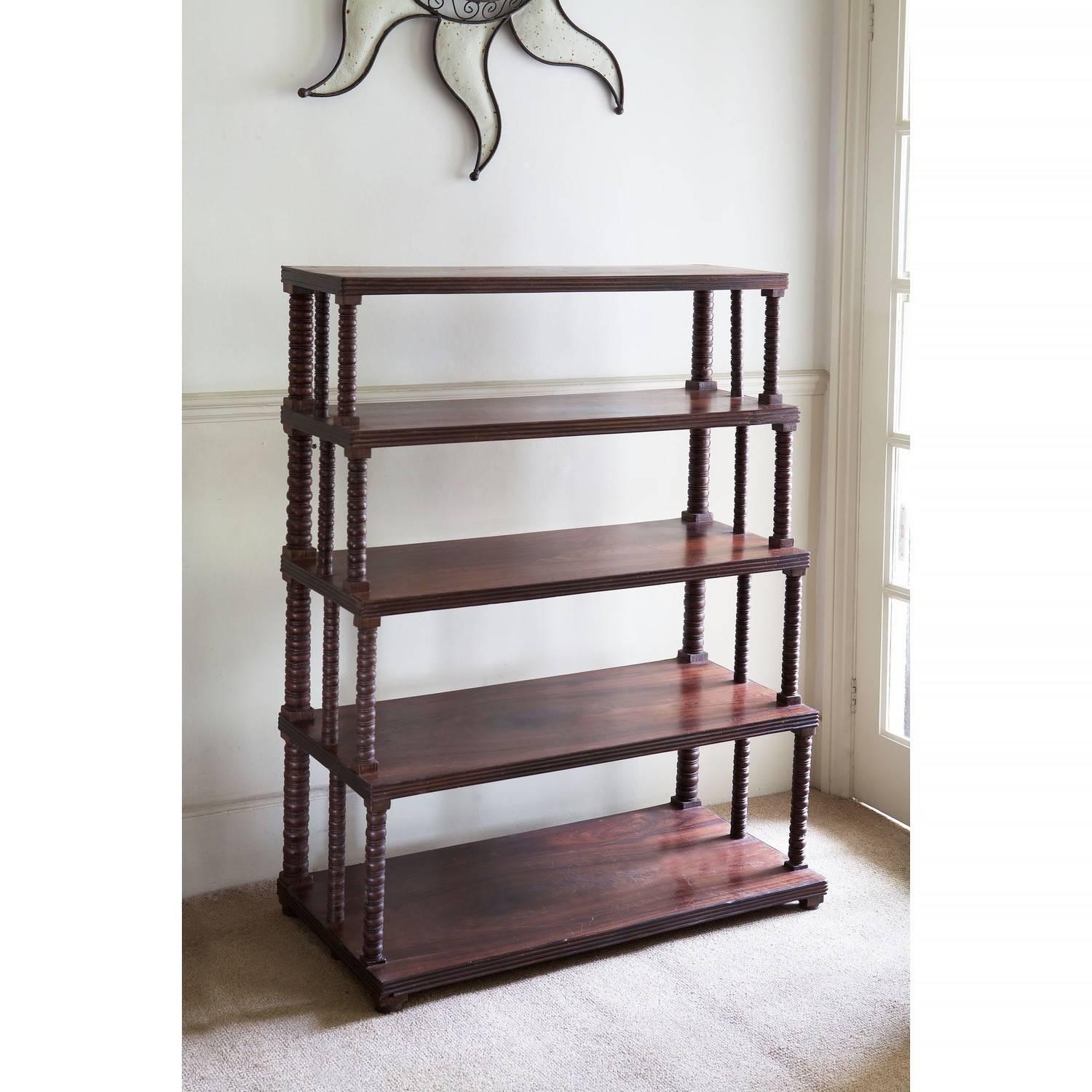 India, circa 1880.

A late 19th century teak etagere bookshelf, with elaborately turned supports to each tier. 

Measures: Height 49 ins (125 cms),
width 37 ins (94 cms),
depth 18 ins (46cms).