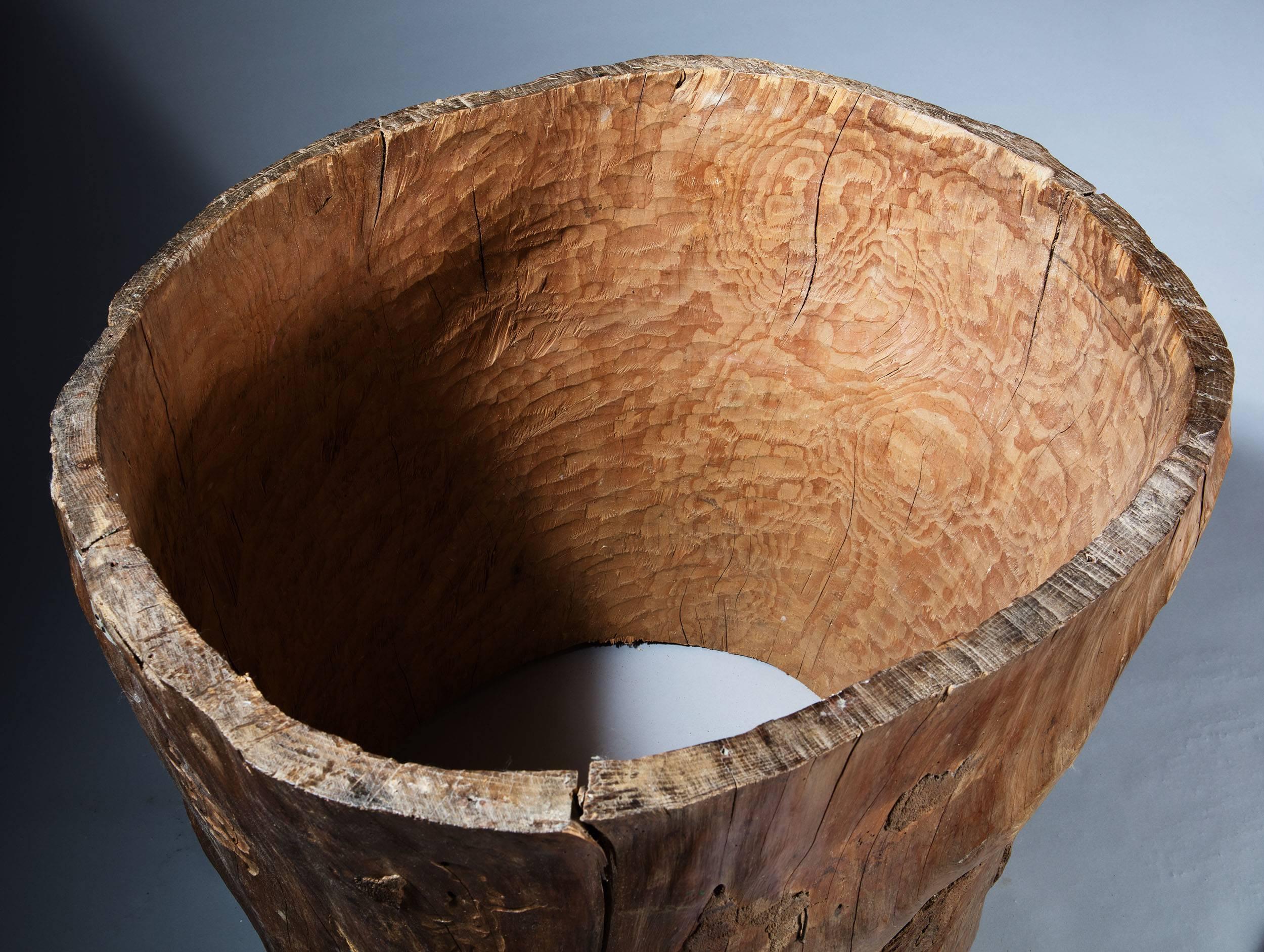 A heroically scaled Hungarian hollowed out tree trunk log basket, having some metal-plate repairs and retaining some original bark.

Measures: Height 32 ins (81 cms)
Width 32 ins (81 cms).
