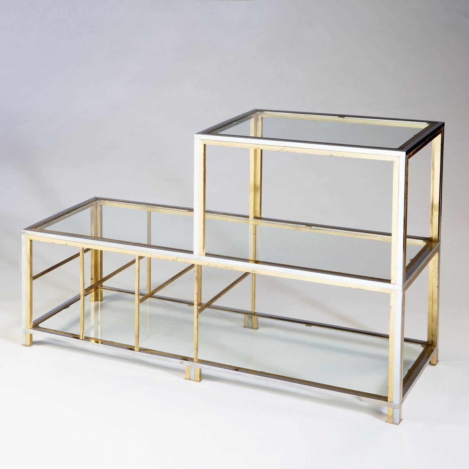 A chrome and brass three tiered stepped etagere. Each tier constructed as bands of the two metals, each element made with fine detail and crispness.
retaining its original lacquer.

In the manner of Romeo Rega.

Italy, circa 1975

Measures: