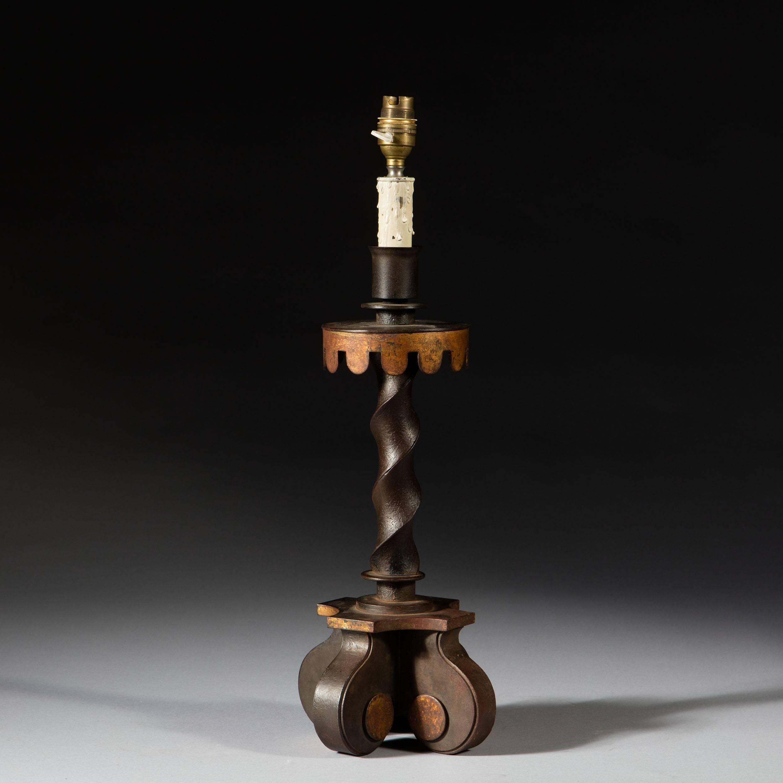A rare and unusual modernist wrought iron table lamp with gold leaf details, fashioned as a solomonic column with shaped gilt drip pan, standing on four scroll feet.

By Gilbert Poillerat. 

Published in 'Gilbert Poillerat , Maitre