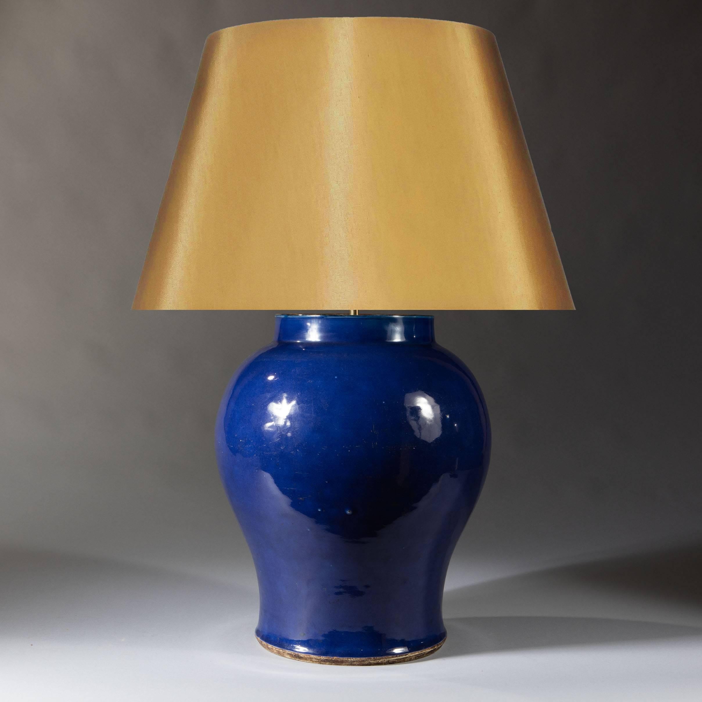 A large 19th century Chinese export monochrome blue glaze vase of baluster form with a dark unglazed rim and foot, now mounted as a lamp. 

Height of vase 18.5inches 47cm
Diameter of Vase 14inches 36cm

Shade not included.