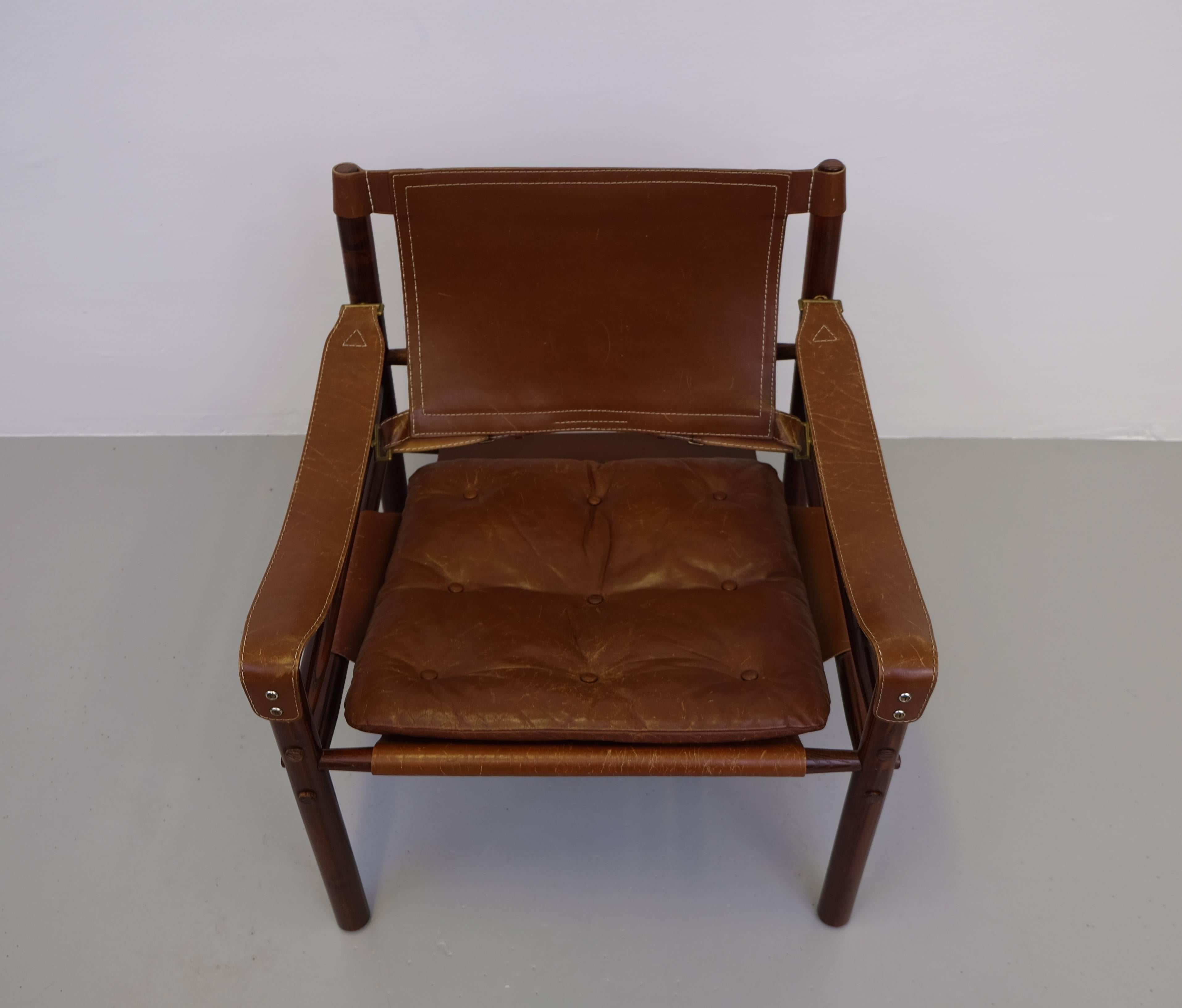 Lovely safari chair or easy chair in brown leather designed by Arne Norell, 1964, produced by Arne Norell AB in Aneby, Sweden, 1960s.
