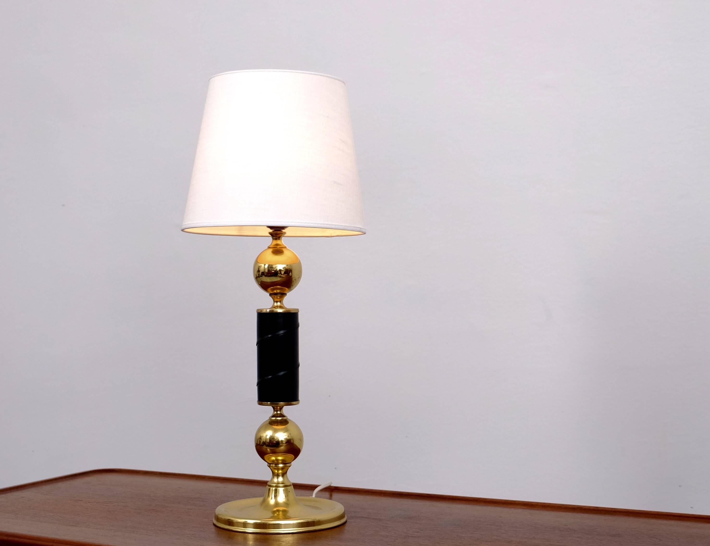 Swedish table lamp in great condition. Original black leather and brass. 
Height including shade: 54 cm.