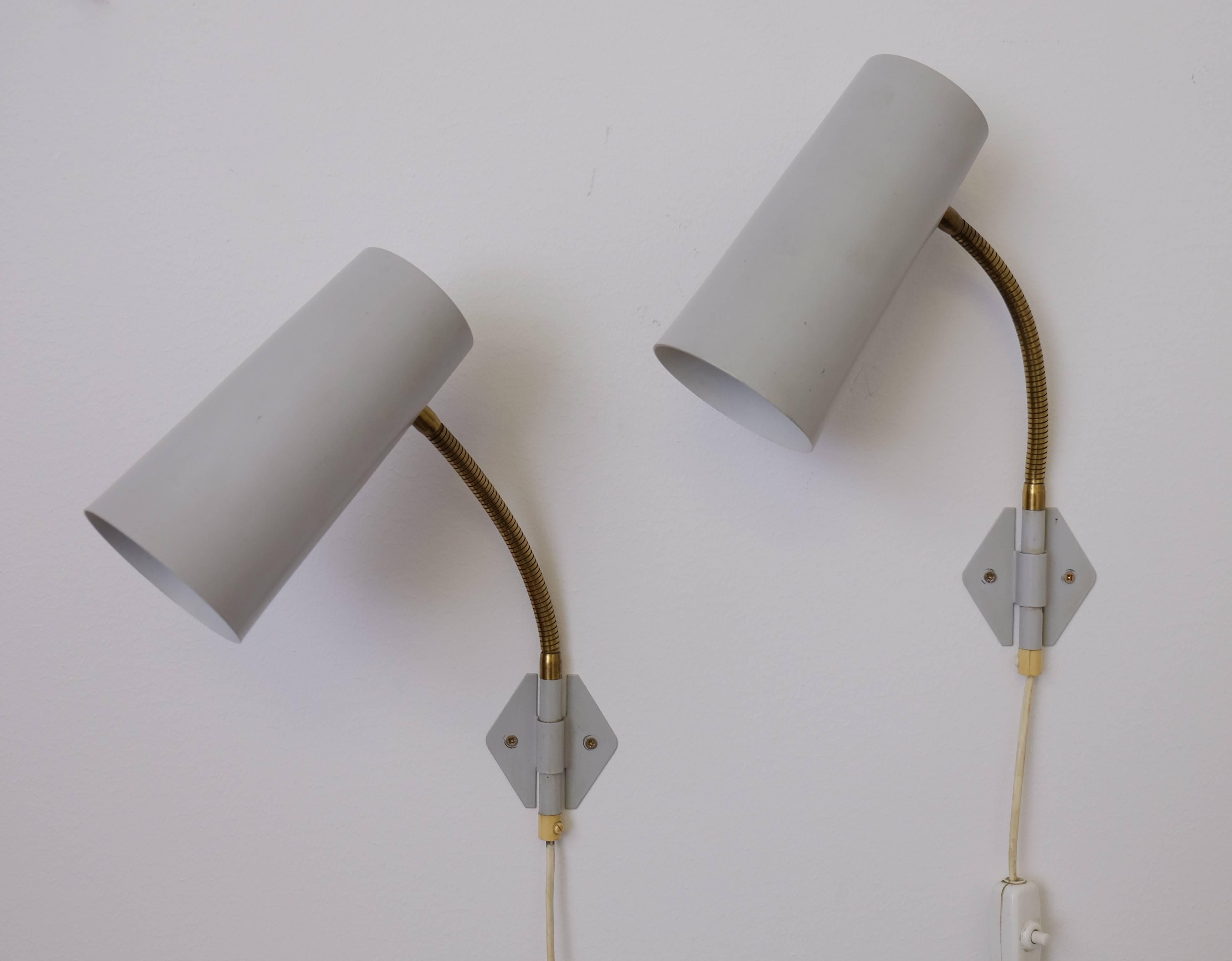 Wall lamps produced in Sweden during the 1950s by Böhlmarks.
Grey painted metal and brass. 
The screen is 19 cm long and 9 cm in diameter.
3 pieces available. Listed price is for a pair. 