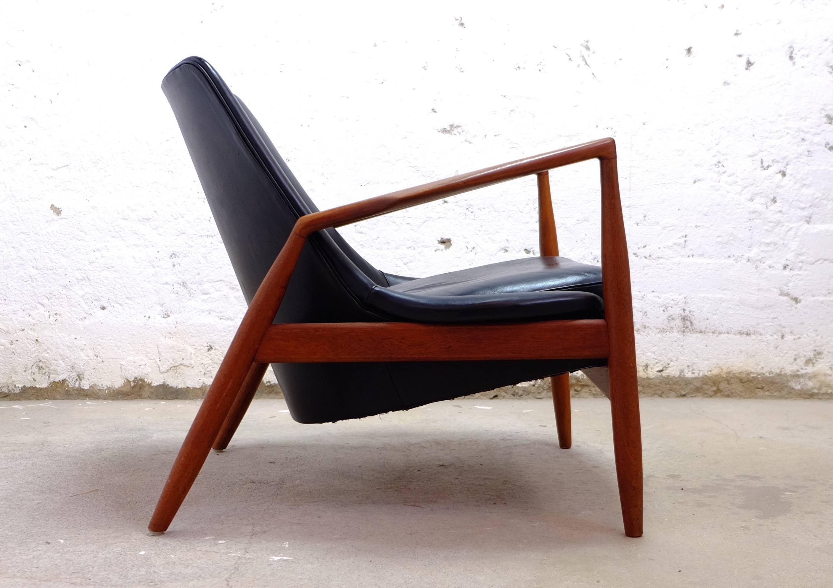 Ib Kofod-Larsen seal easy chair. Teak and original black leather. Produced by OPE.
