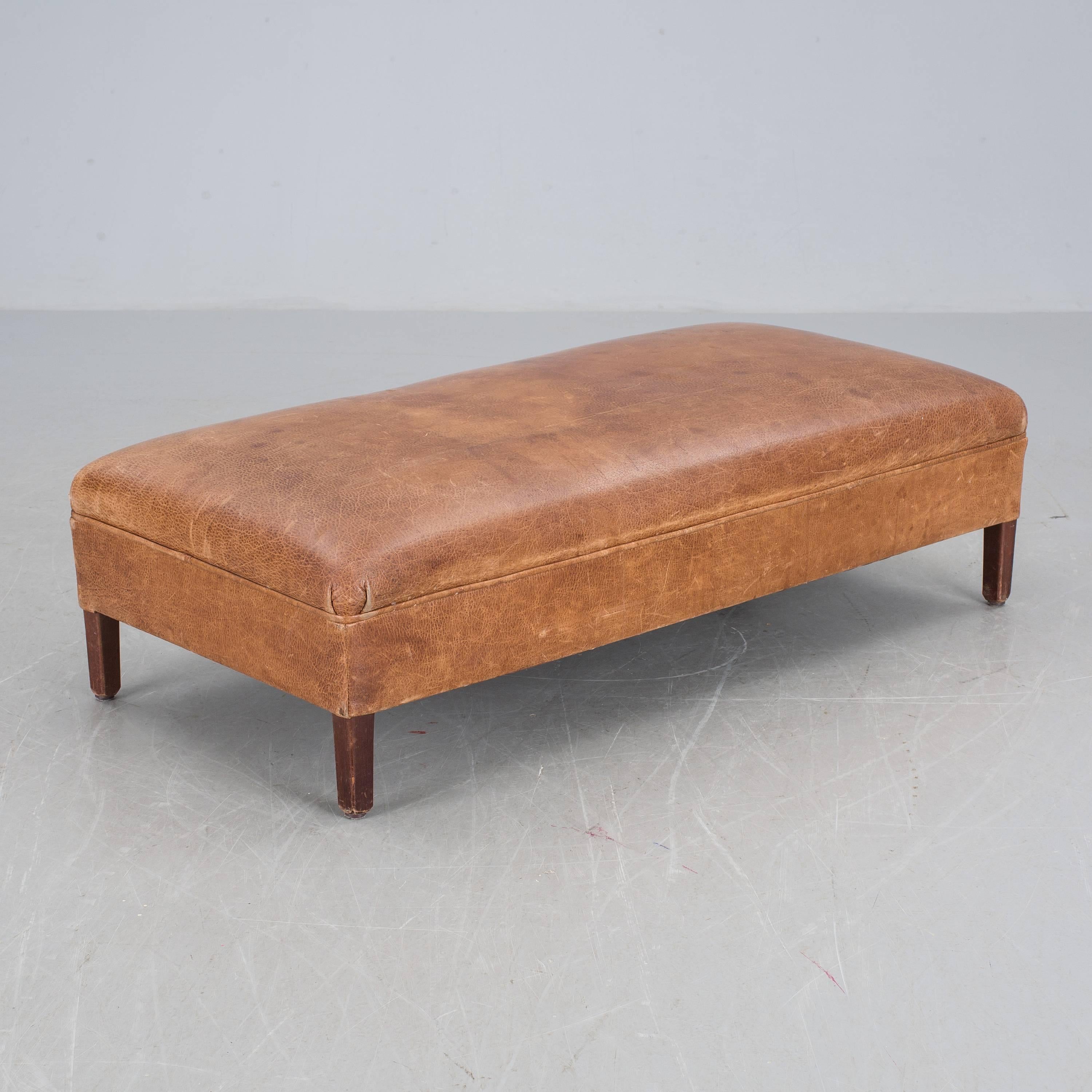 Large cognac brown leather bench or ottoman with stunning patina.