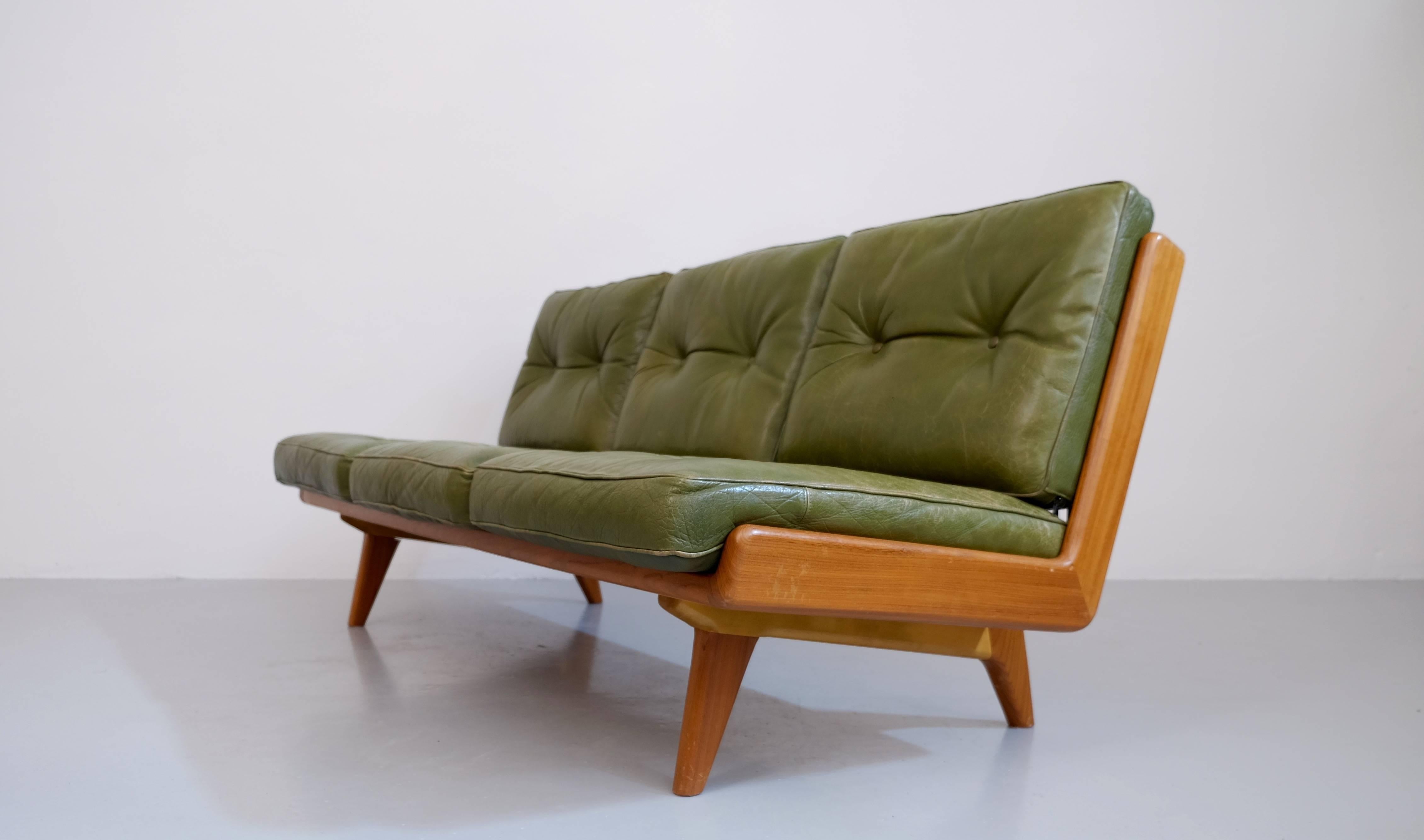Excellent original condition. 
Original green leather cushions, braided natural leather in the back.