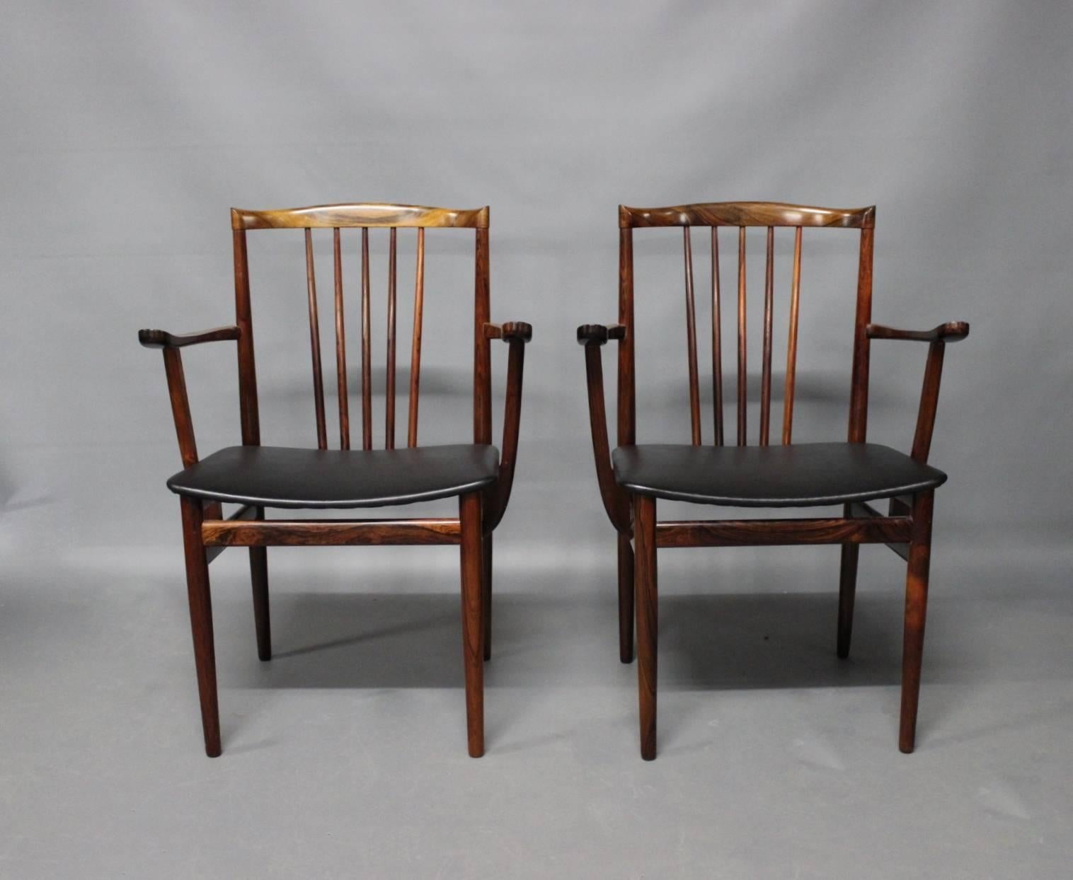 A pair of armchairs in rosewood and seat of Classic black leather designed by Henning Sørensen in 1968.