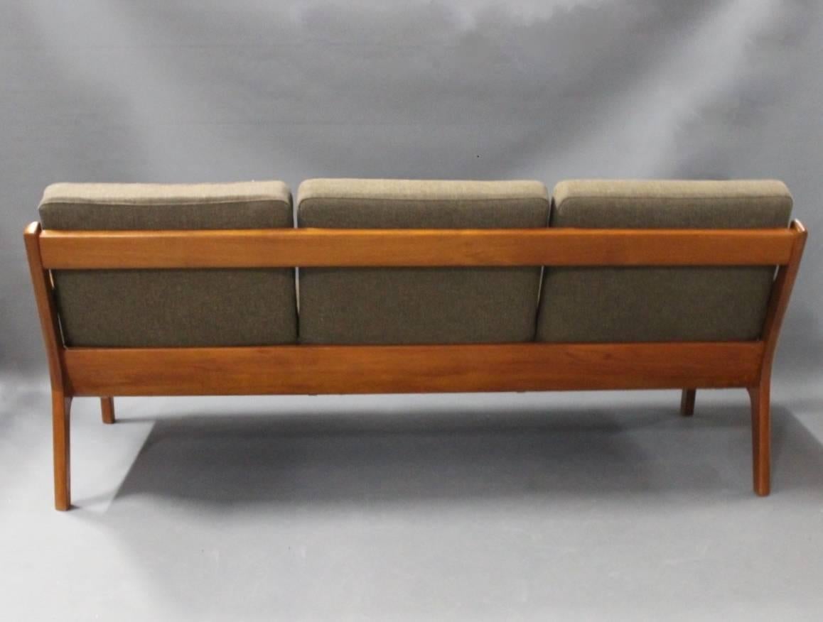 Three-seat sofa, model Senator 166, designed by Ole Wanscher in 1951 for France & Son. The sofa is in teak and upholstered in dark wool.