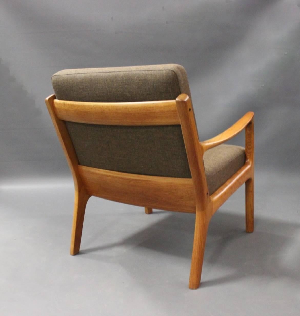 Lounge chair, model 166, designed by Ole Wanscher in the 1950s for France & Son. The chair is in teak and upholstered with dark wool.