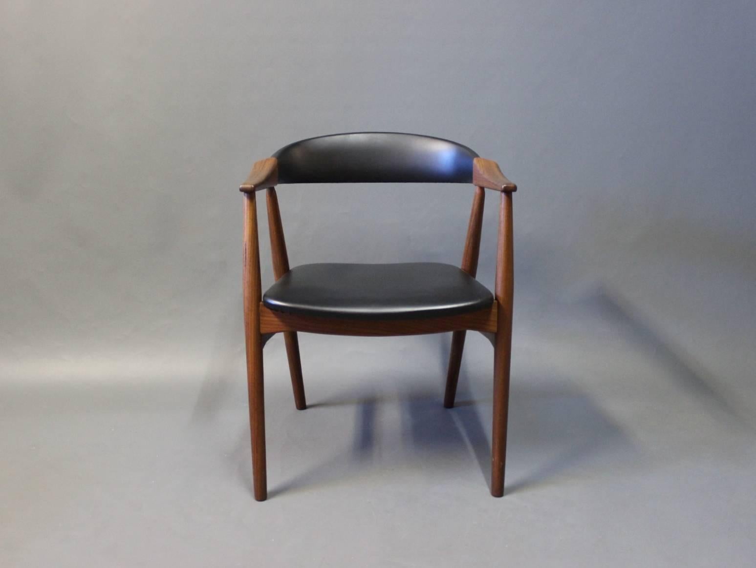 Armchair in teak and upholstered with artificial leather of Danish design from the 1960s.
