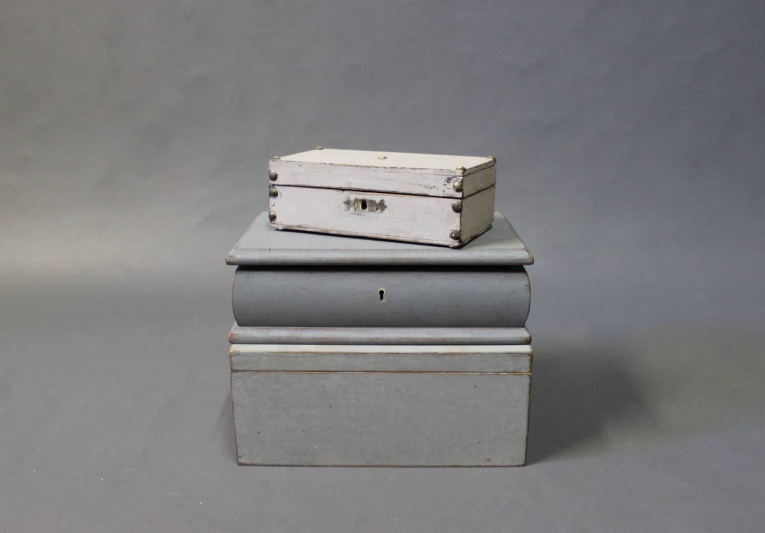 A set of three grey painted shrines from the year 1880-1930 all in the style of Gustavian. 
The measurements are form small to large:
H 6 cm, W 19 cm and D 10 cm.
H 8.5 cm, W 27 cm and D 17.5 cm.
H 11.5 cm, W 19 cm and D 26.5 cm.
 