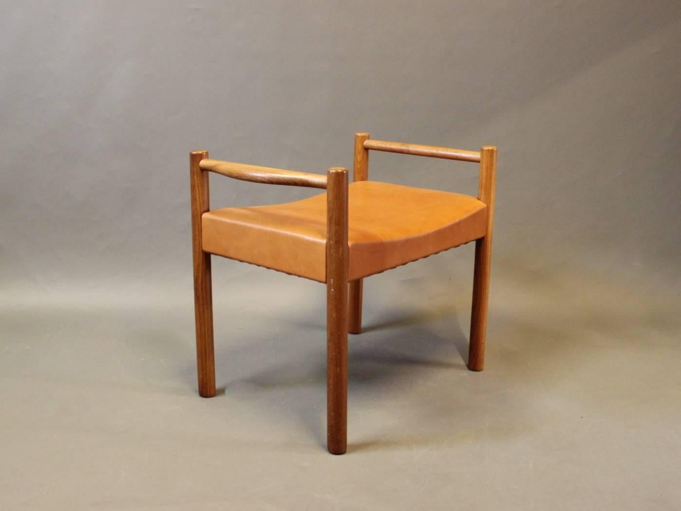 A pair of stools upholstered in cognac colored elegance leather and frame of elmwood. The stools are from the 1960s and of Danish Design.