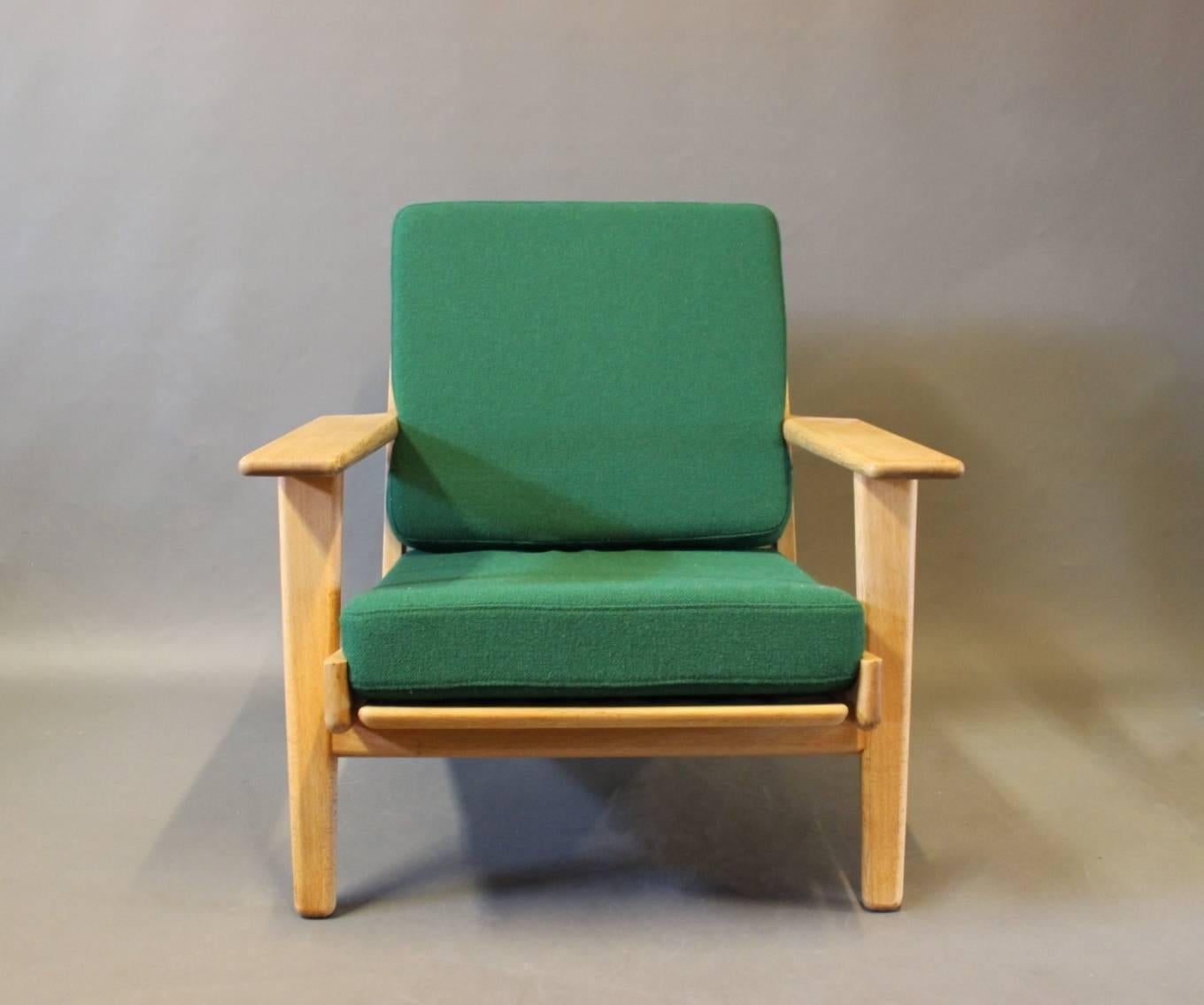 Armchair, model GE290, designed by Hans J. Wegner in the 1950s and manufactured by GETAMA in the 1960s. The chair is of oak and with cushions upholstered in dark green Hallingdal wool.