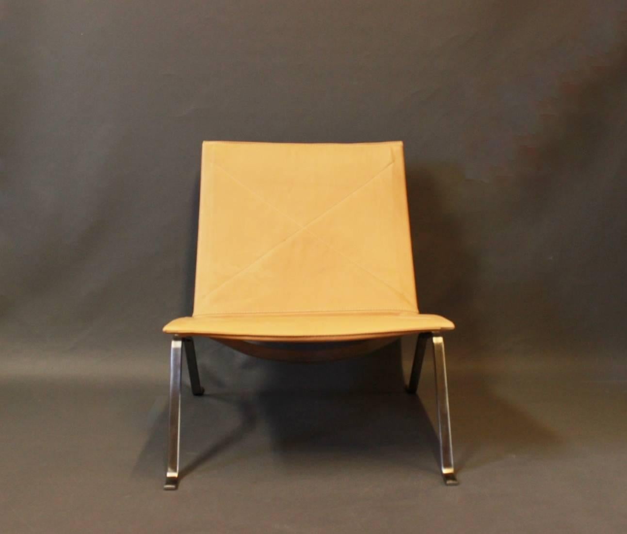 A PK22 easy chair designed by Poul Kjærholm in 1955 and manufactured in the 1970s. The chair is with light natural leather and frame of chrome.