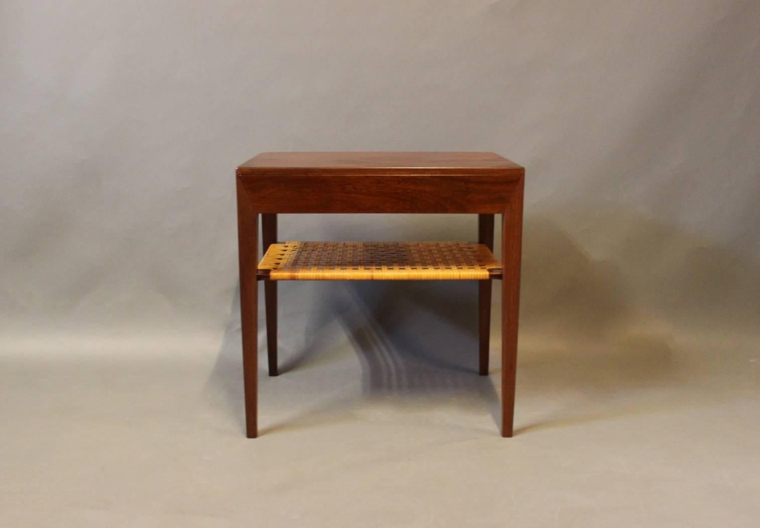 Small bedside table in dark wood and with a paper cord shelf by Severin Hansen for Haslev furniture factory. The table is in great vintage condition.