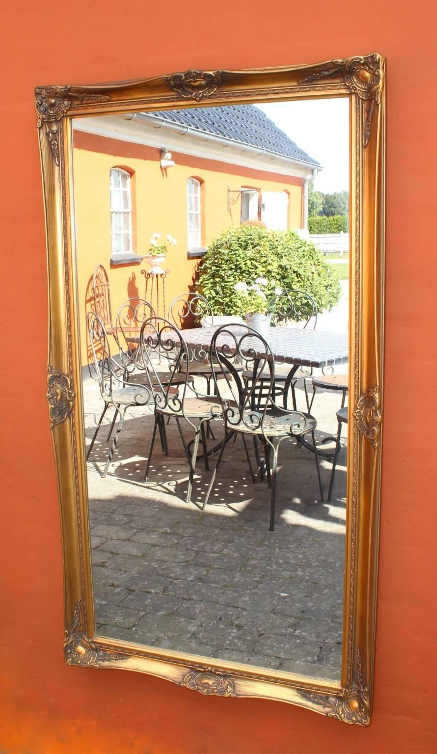 Large mirror with a gilded frame from around the 1930s. The mirror is from Denmark and is in great antique condition.
