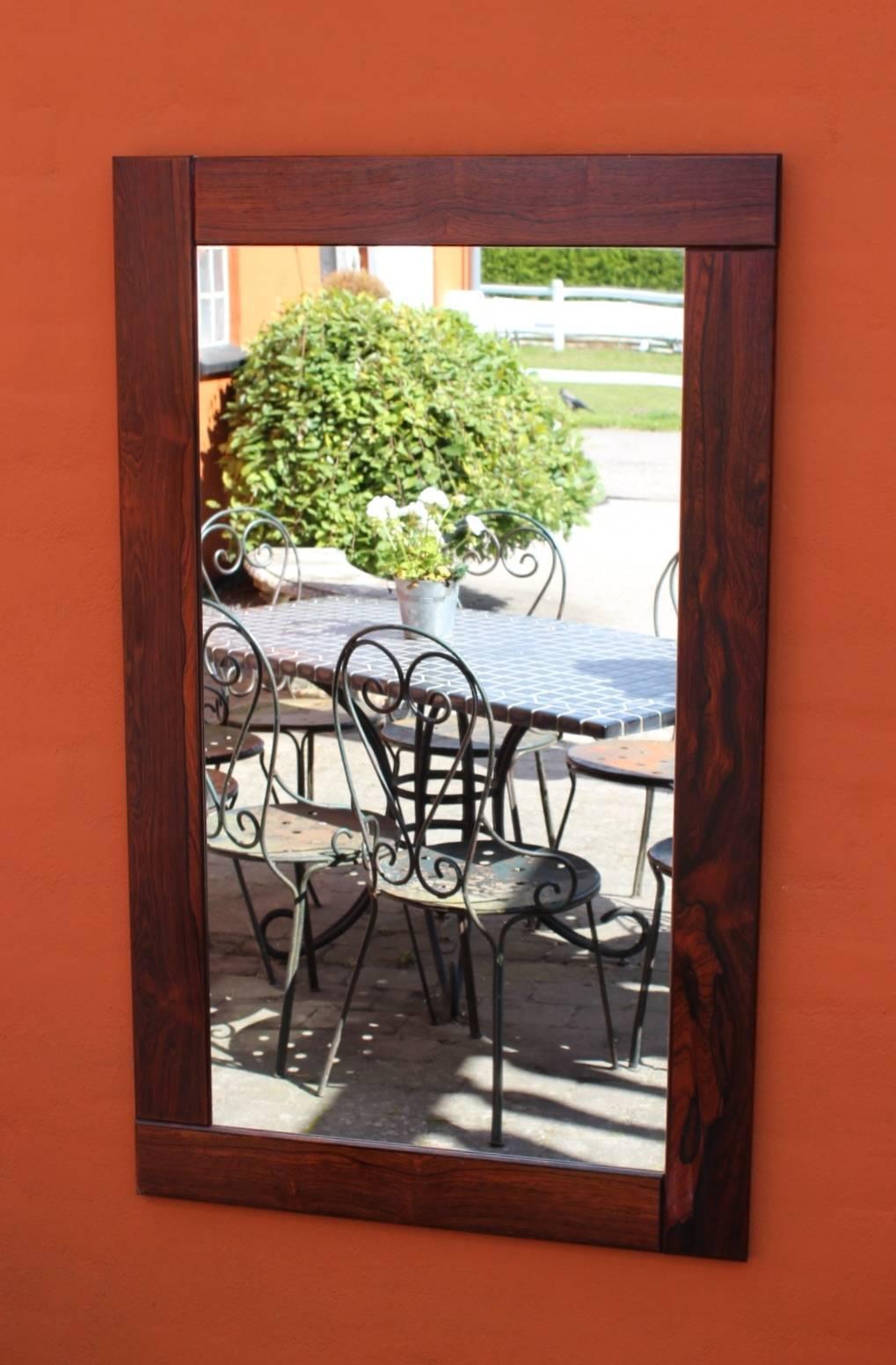 Mirror in wide frame in rosewood of Danish design from the 1960s. The mirror is in great vintage condition.