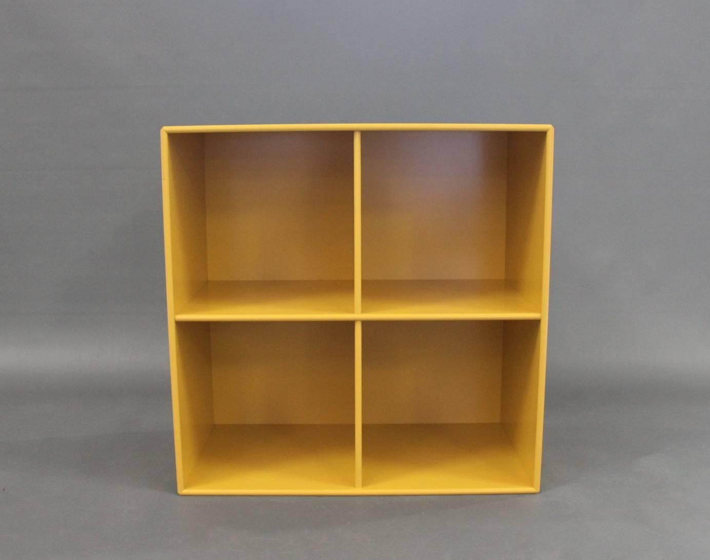 Bookcase, module 1112, in yellow by Montana with four spaces.
