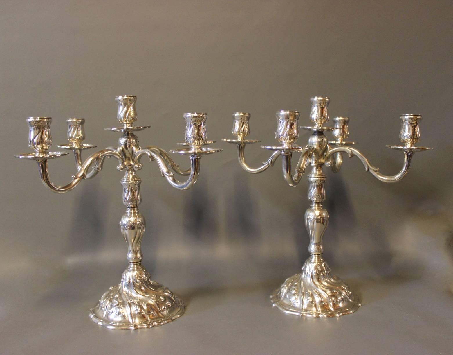 A pair of five armed candelabra in 925 sterling silver by English Silver House and stamped AxS. They are newly polished and in great condition.