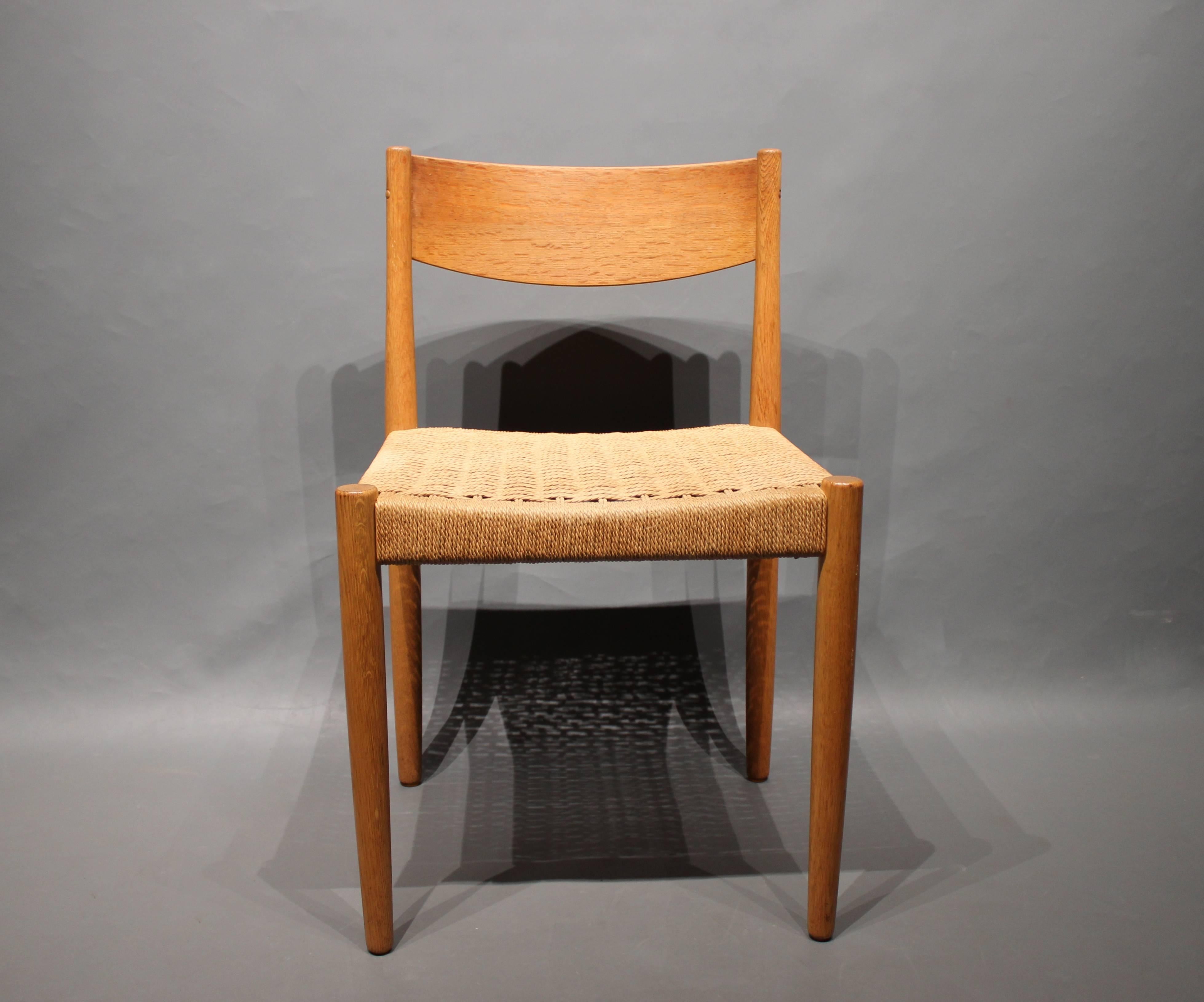 Set of six dining room chairs in oak with papercord seat designed by Poul M. Volther and manufactured by Frem Røjle. The chairs are in great vintage condition and from the 1960s.