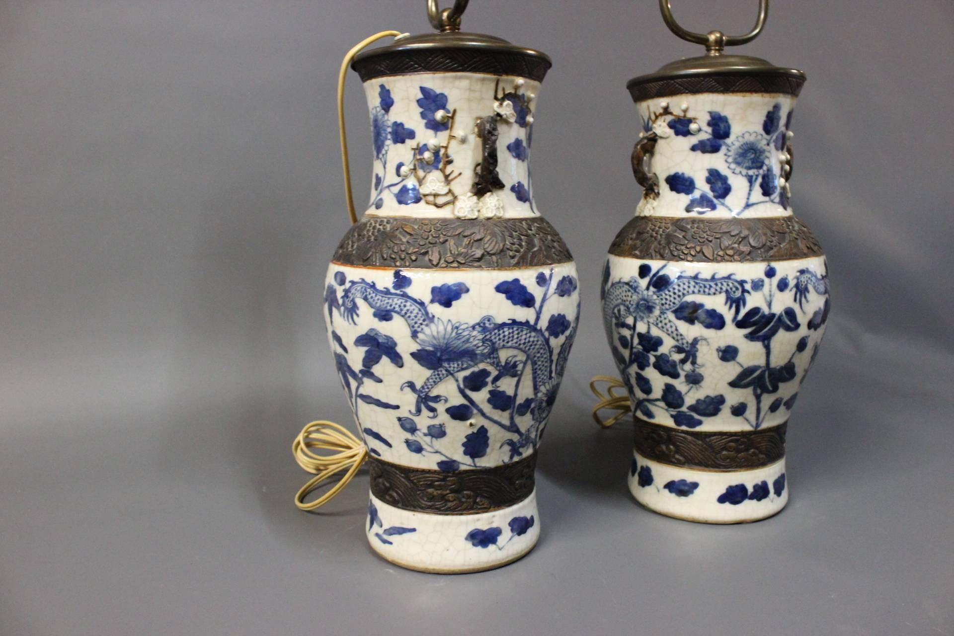 A pair of Chineese porcelain table lamps from around the 1920s. The table lamps are beautifully painted and stamped with a chinnese stamp on the bottom. 