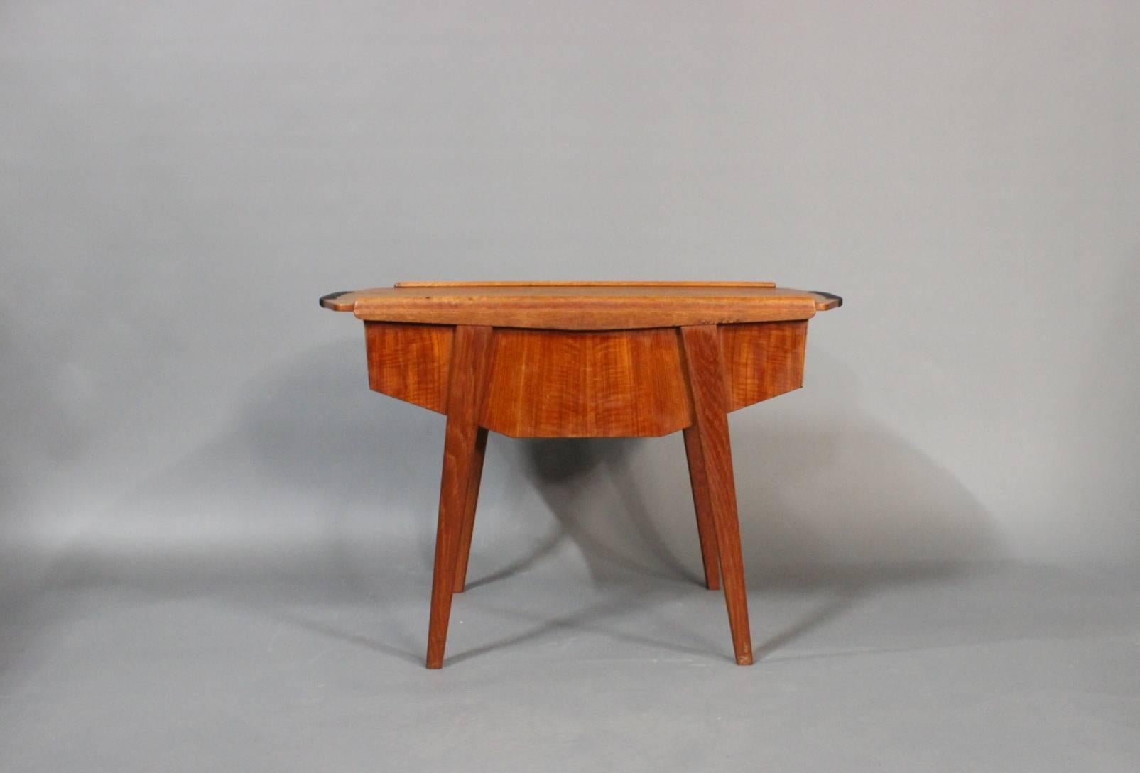 Sewing table in teak with sliding top plate and compartment beneath by a danish furniture manufacturer from around the 1960s. 