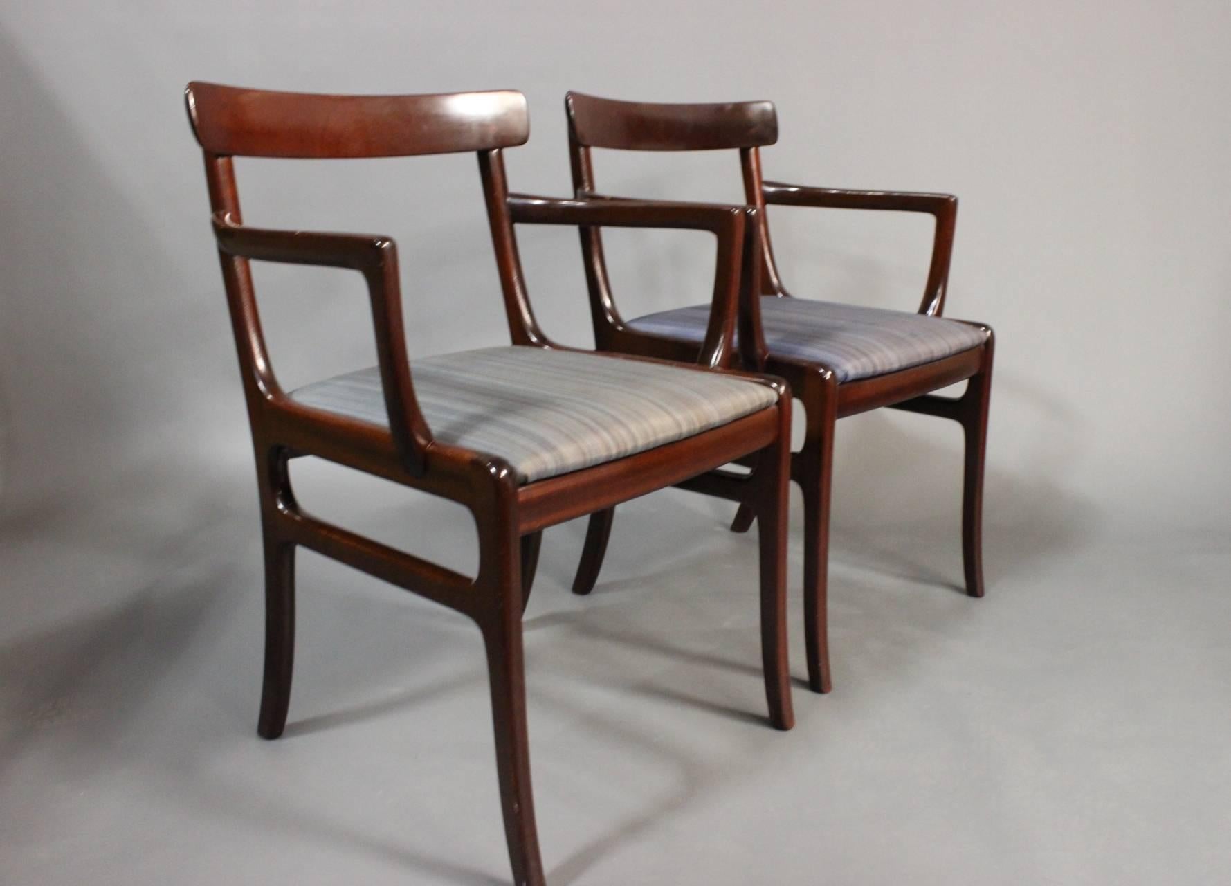 A pair of "Rungstedlund" armchairs in mahogany and uppolstered blue fabric from around the 1940s. The chairs are designed by Ole Wanscher and manufactured by P. Jeppesen. 