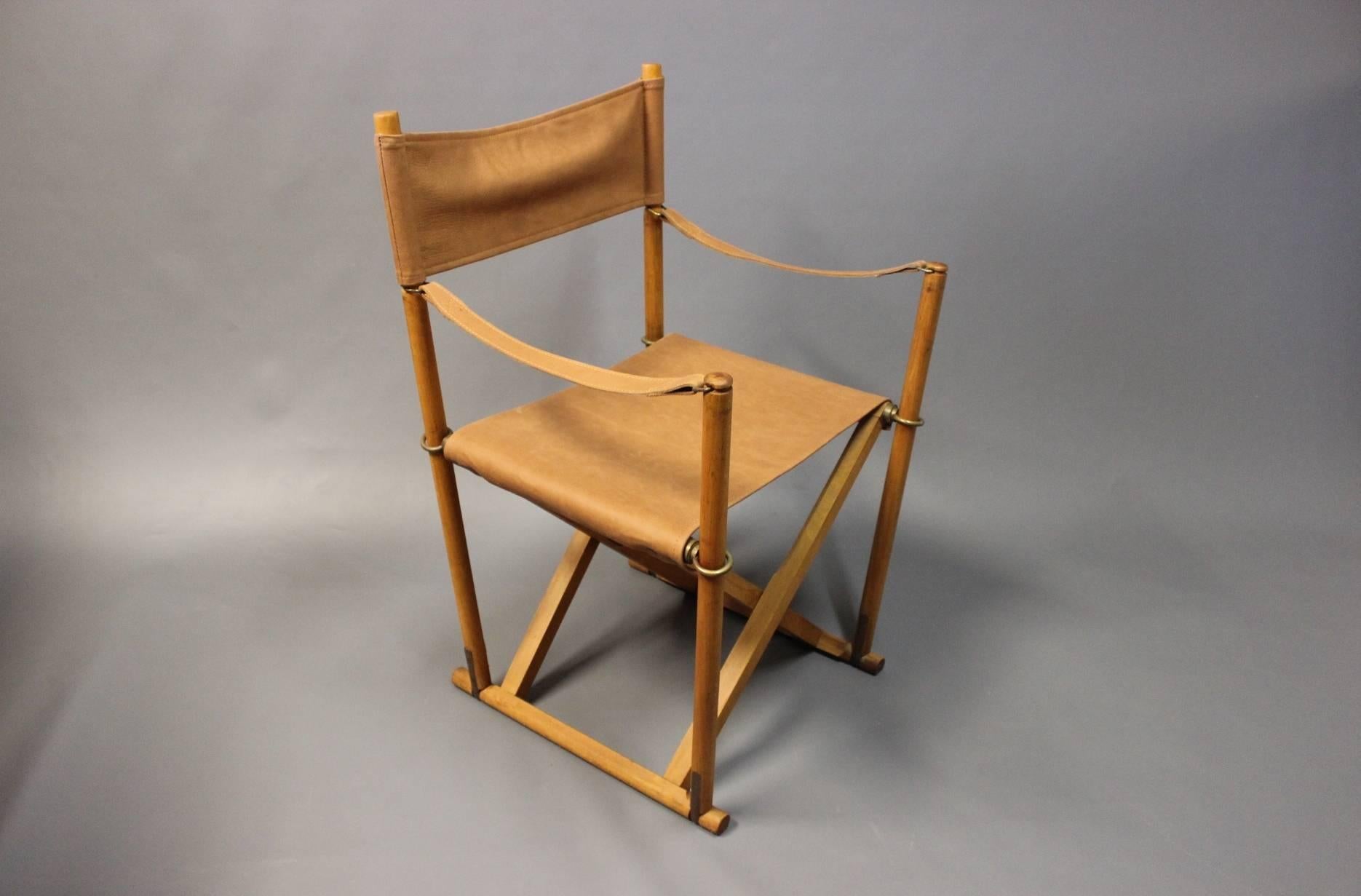 Three folding chairs, model MK99200, designed by Mogens Koch in 1932 and manufactured by Interna, Denmark, 1960s. The chairs are in polished beech, with brass rings and patinated leather seats.