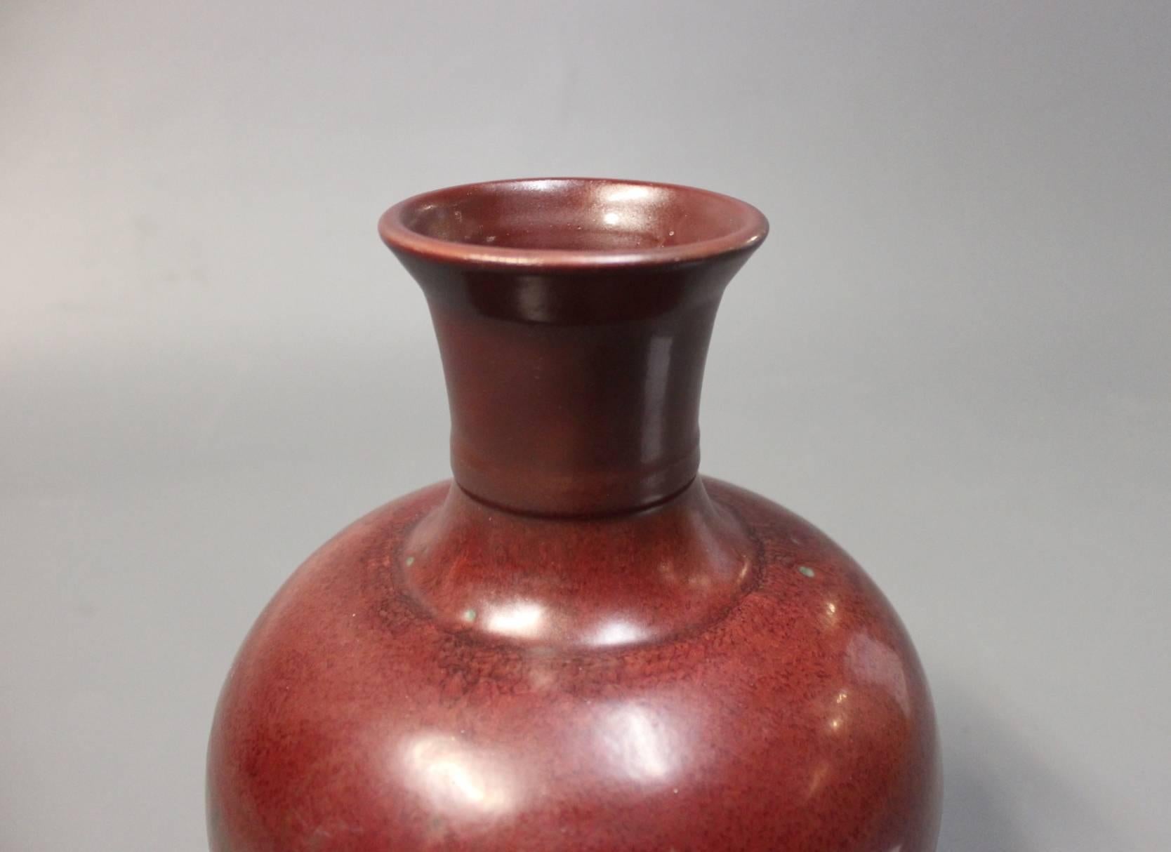 Large oxblood colored in glazed stoneware. Manufactured by Royal Copenhagen and designed by Carl Halier in 1937.