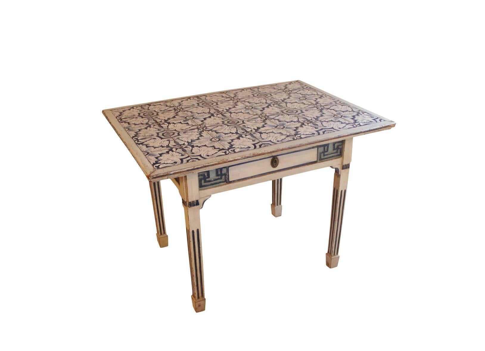 Tile-top table made in Denmark in 1780, with Dutch tiles with a small drawer in the front. The table is of the Louis XVI period and is in grey and blue painted wood.