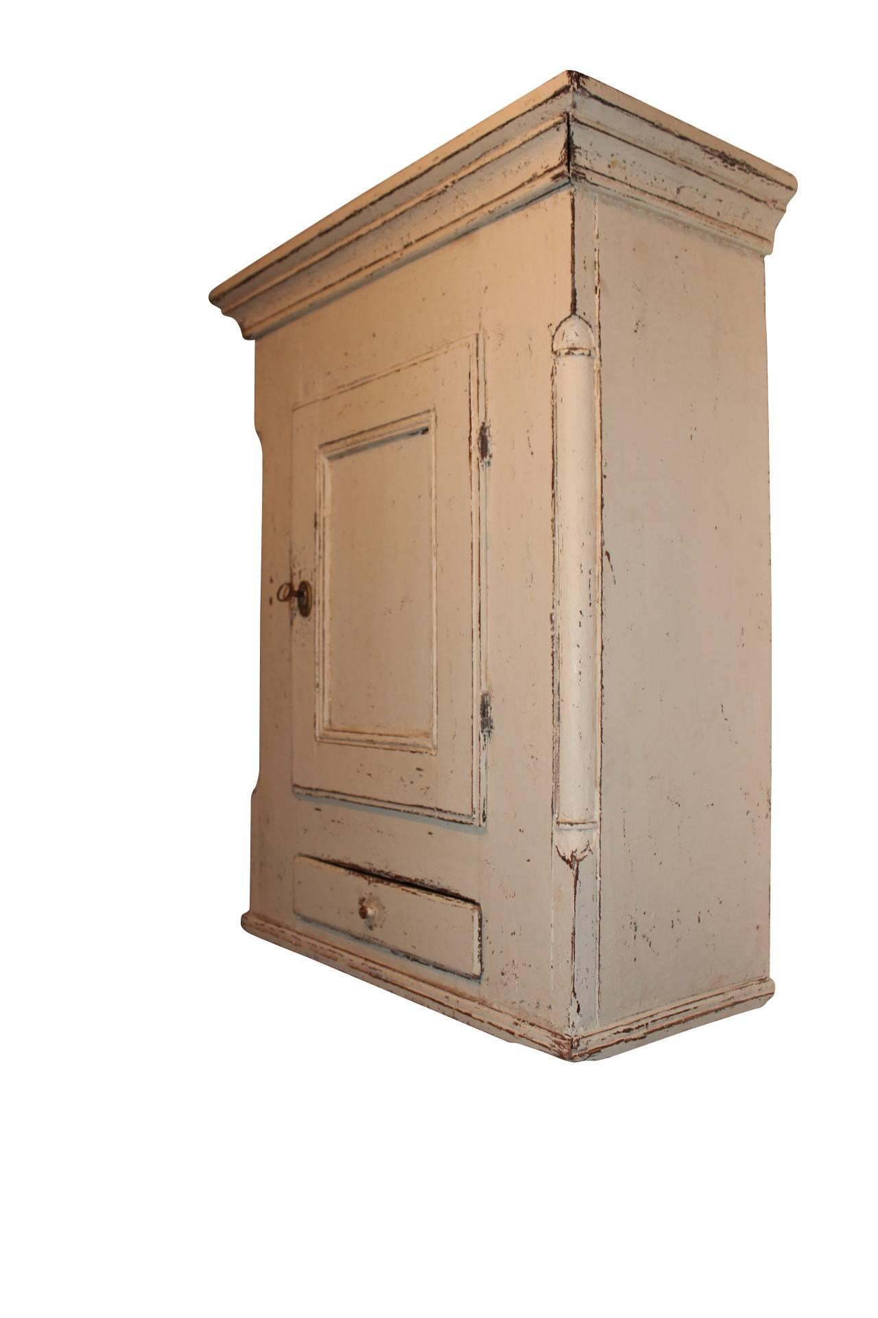The grey painted antique Gustavian style wall cupboard from Sweden, dating back to around 1860, is a captivating piece that reflects the elegance and craftsmanship of the Gustavian era.

The Gustavian style originated in 18th-century Sweden during