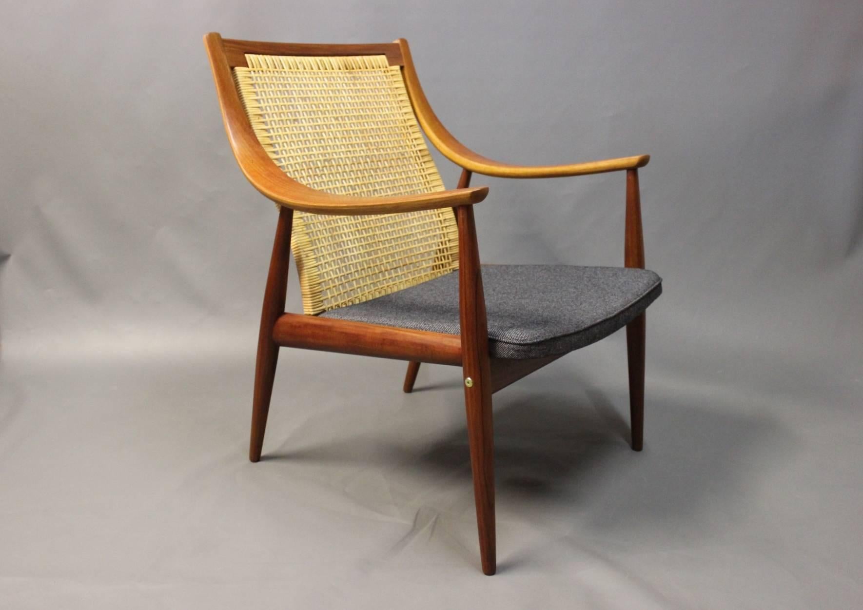 Armchair designed by Orla Mølgaard Nielsen and Peter Hvidt. The chair is in teak with paper cord back and newly upholstered grey seat, of Danish design from the 1960s.
  