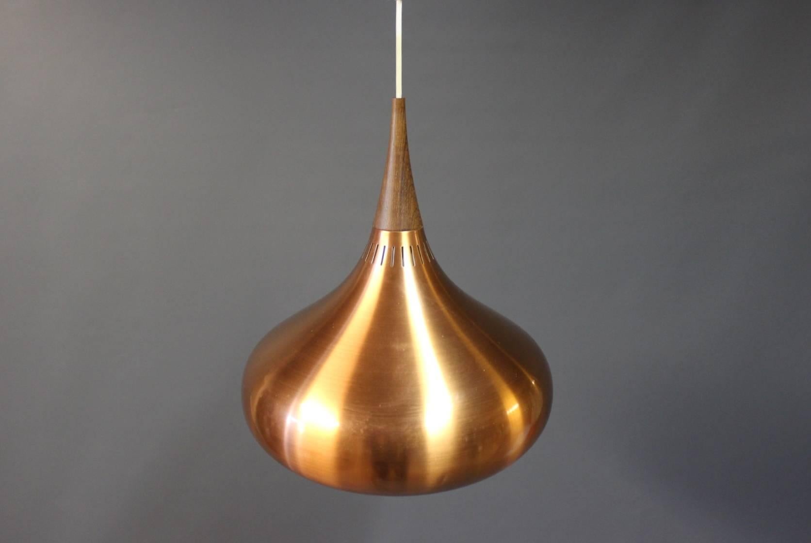 This "Orient" copper pendant, model P2, was designed by Jo Hammerborg for Fog & Mørup in Denmark in the 1960s. This lamp is in brushed copper and rosewood.