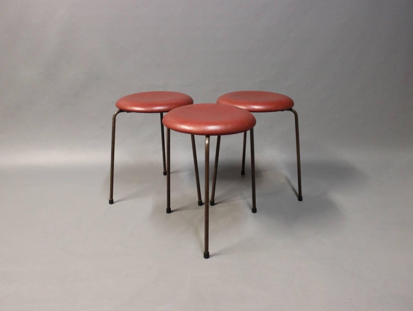 Dot stool, model 3107, designed by Arne Jacobsen in the 1950s and manufactured by Fritz Hansen in the 1960s. The stool have recently been upholstered with Classic Indian red leather. We only have one stool left. 
 