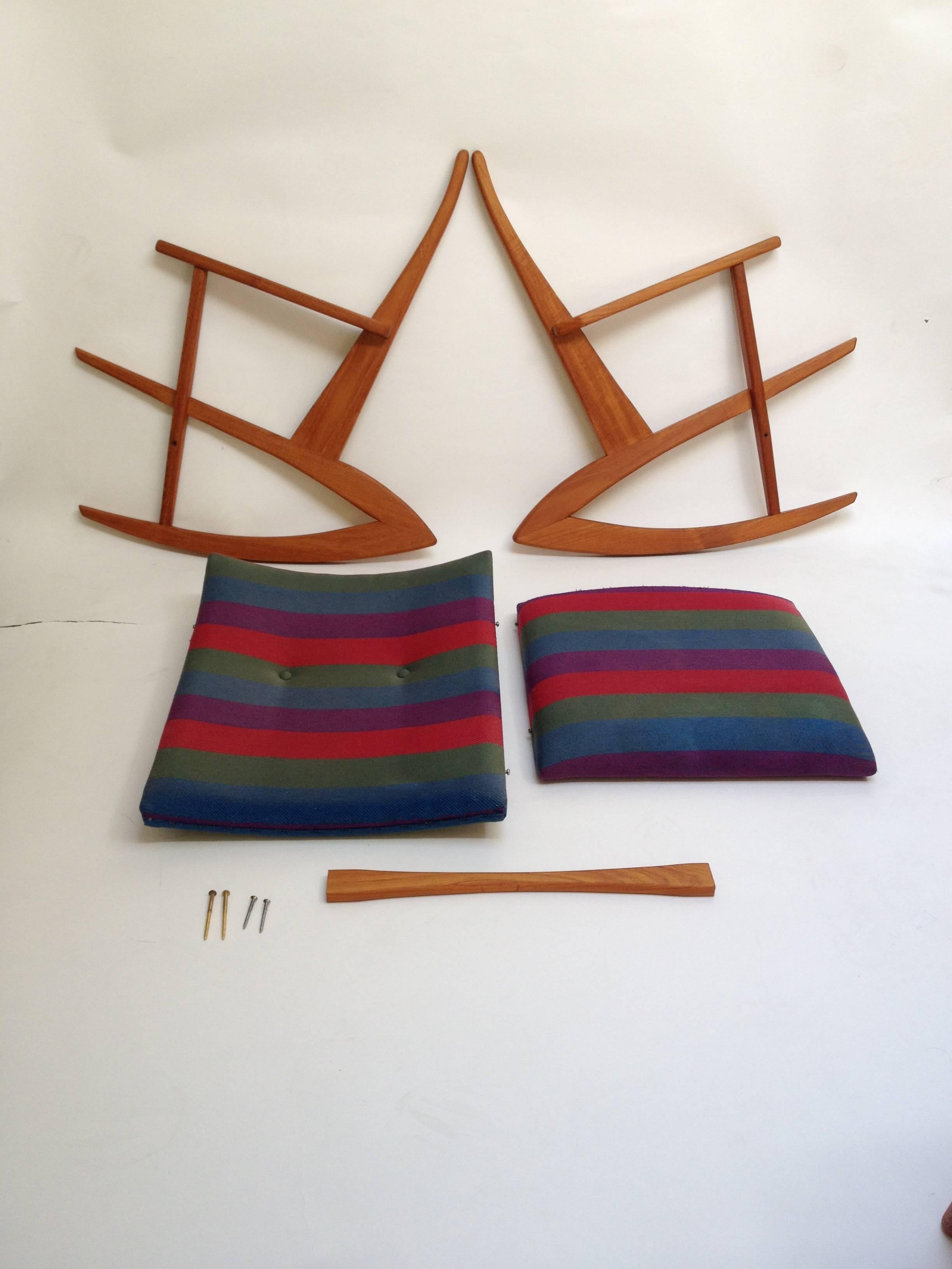 Incredible coveted Mid-Century Modern teak rocking chair with the original striped fabric designed by Soren Jensen, design year 1958. The wood is in very good vintage condition and the fabric is good, it has been cleaned, but it does have a stain