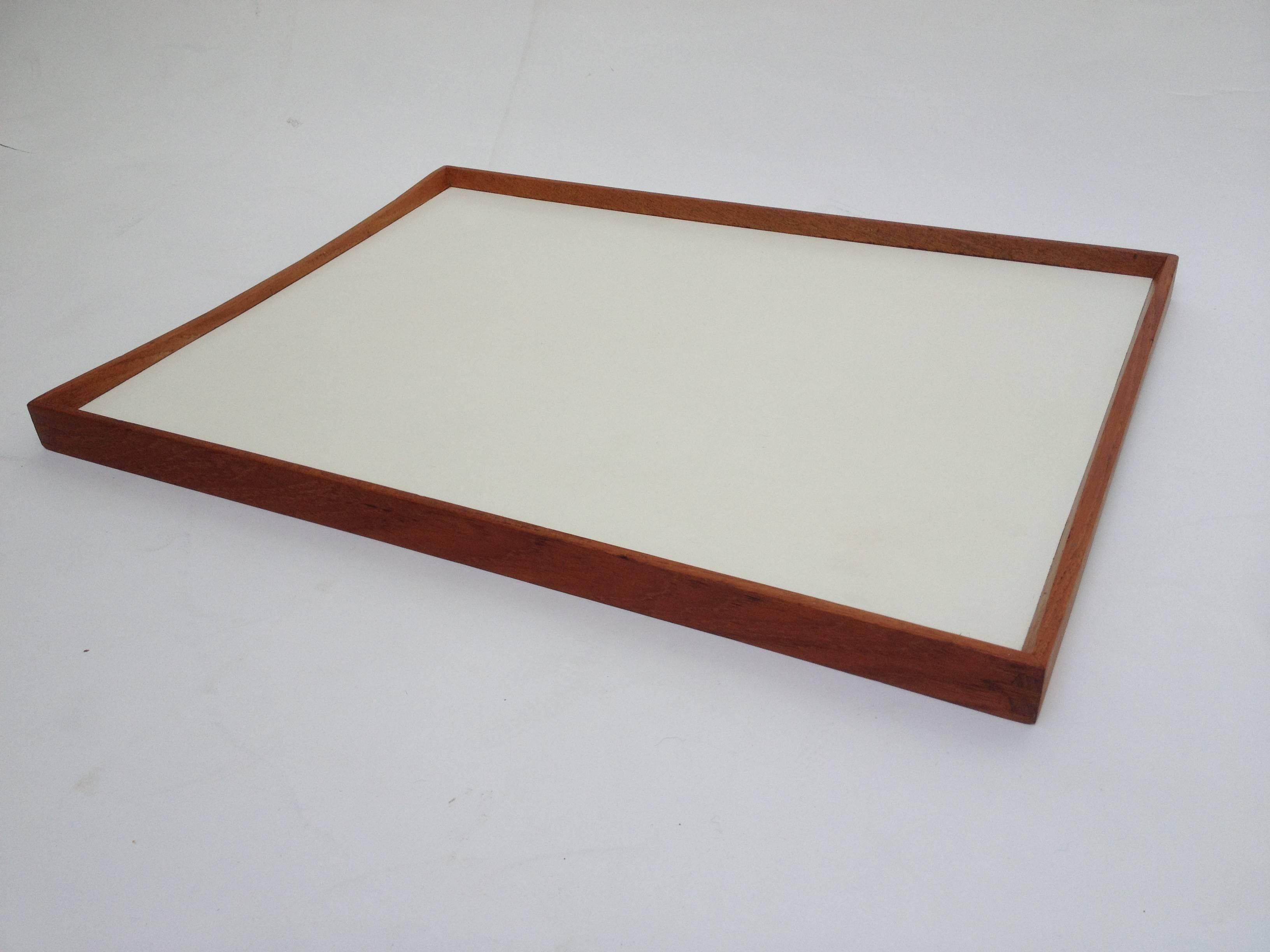Gorgeous reversible tray designed by Finn Juhl, lovely dovetailed teak frame with off white and black laminated centers, very nice vintage condition, some wear to the tray tops and the wood... minor chip repair on one side (see photo) very well
