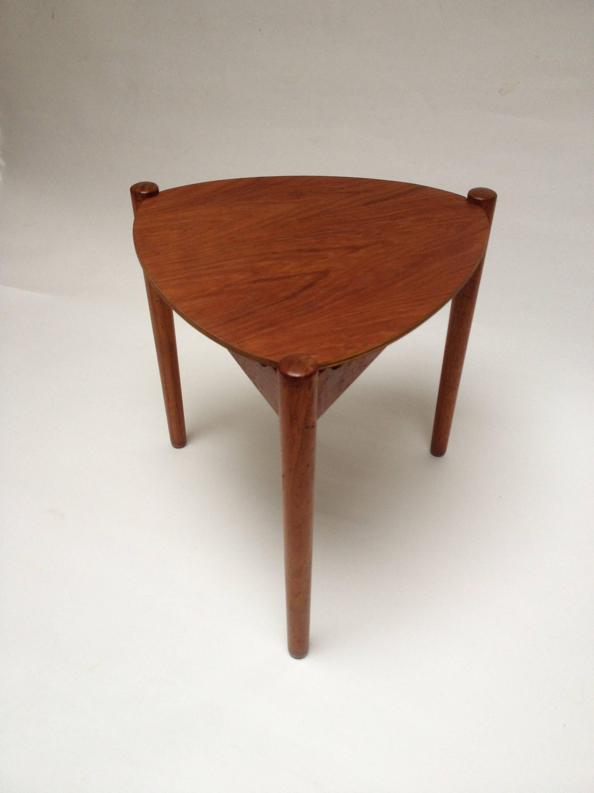 Lovely rare reversible three legged stool and side table designed by Hans Olsen, circa 1950s. Unique design perfect for small spaces! There is a chip in the top of one of the teak side rails (see pic) nothing that affects the structure and there is