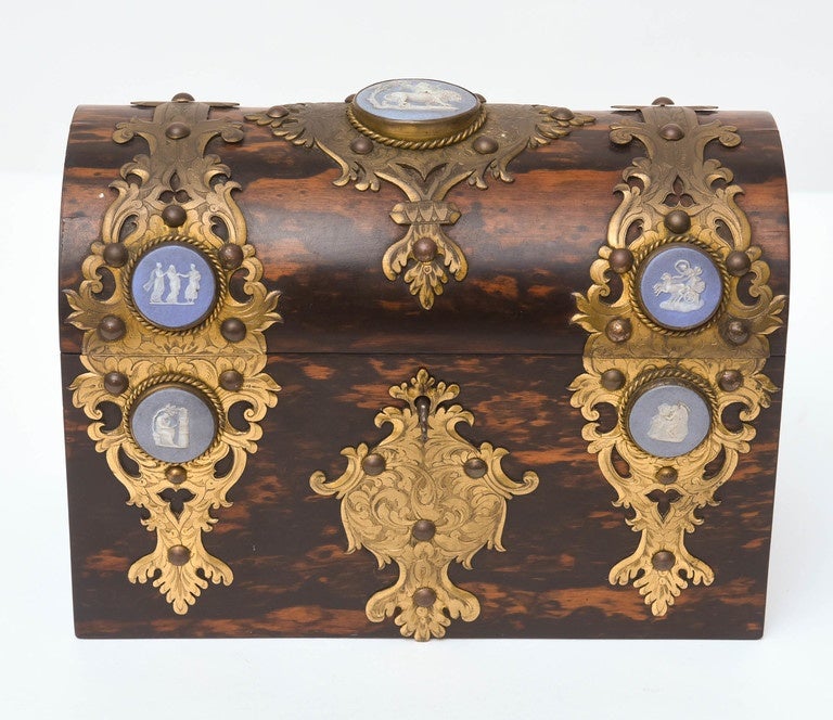 A fine letter box signed Trussell {Brighton]. The dome-top lid is lined with silk and the body contains 4 partitions for organization of paper. The 7 differing medallions are framed with fine metal overlays.