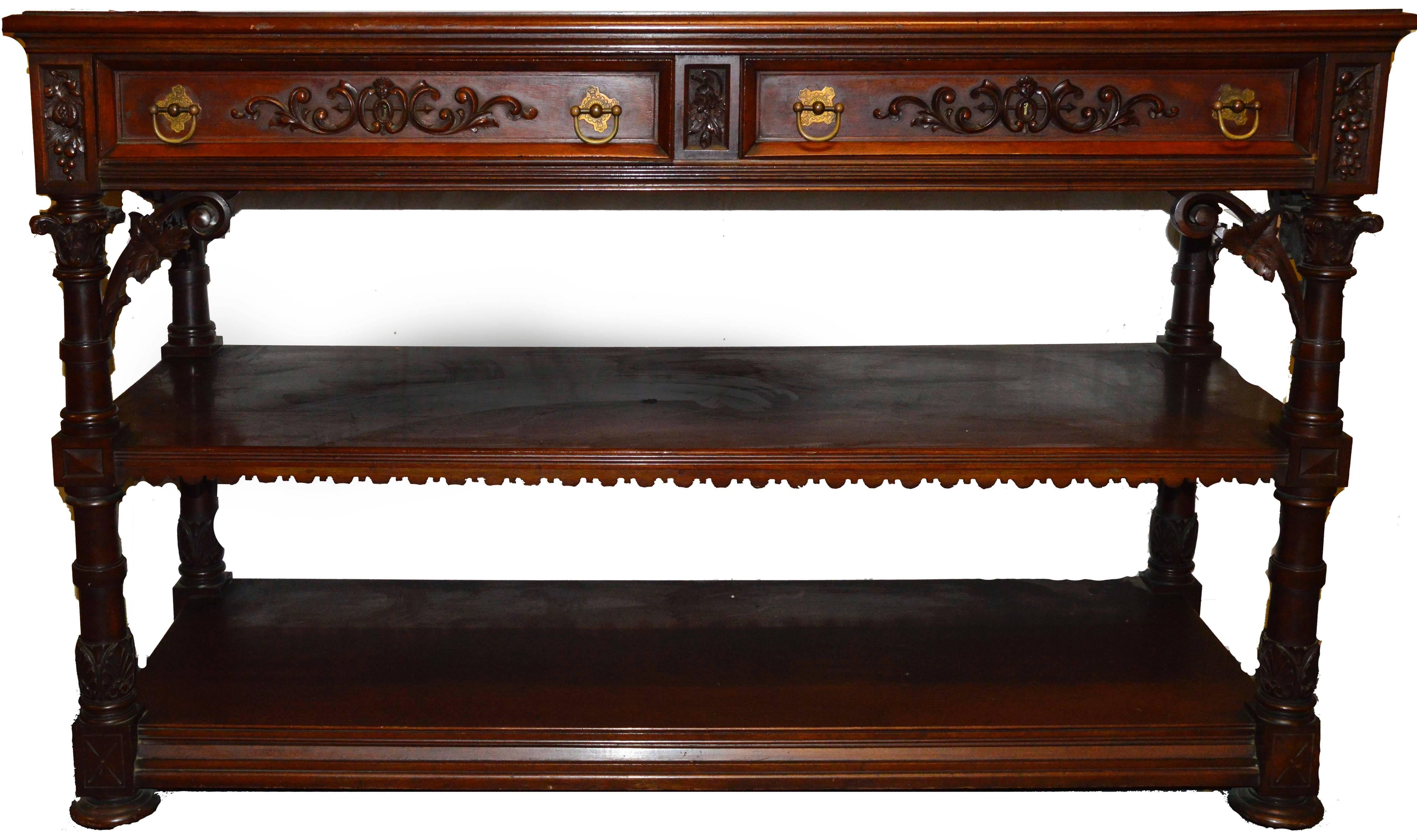 Herter brothers era and style wine server in mahogany and walnut. Carved grape and leaf motif. Carved shelf side garnishment trim (One missing). Circa 1878-1898. Original finish. Breaks down in tow three pieces, top shelf, second shelf and base. Two