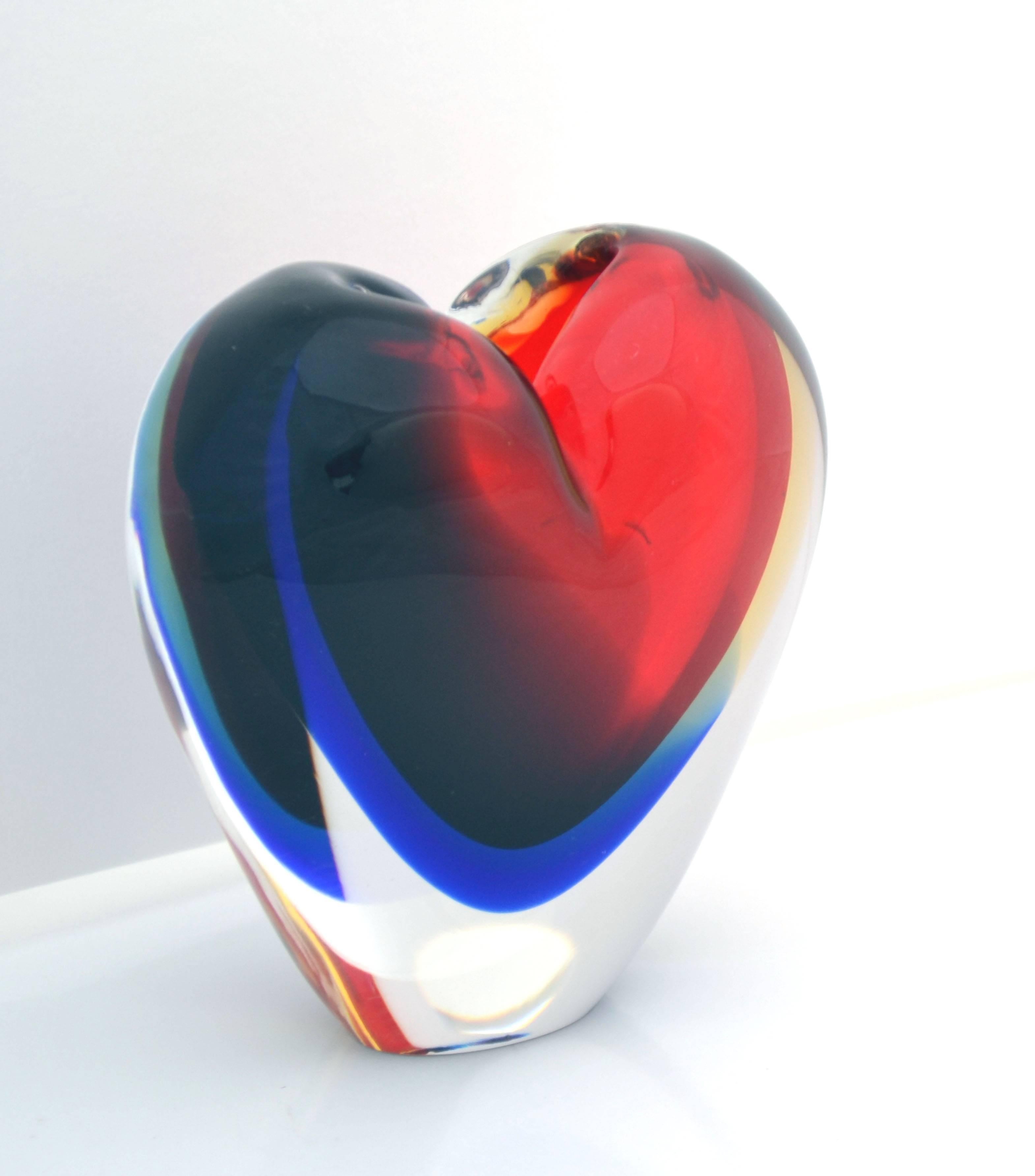 This is a stunning and beautiful dramatic example piece of Italian Murano 20th century art glass using the Sommerso technique and red and blue colors resulting in a magnificent and very eye catching free-form heart-shaped glass vase with very