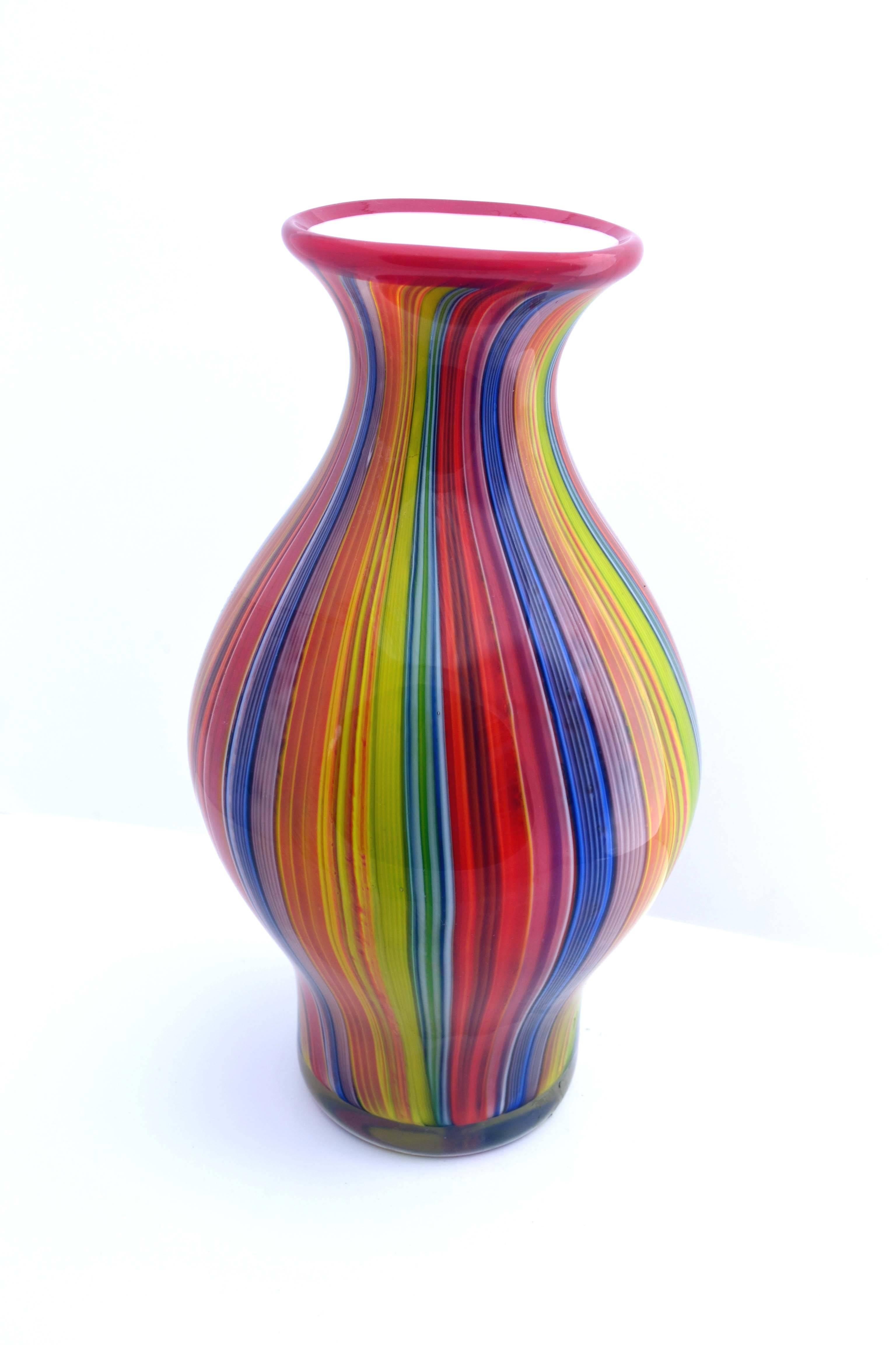 Lively and chic, this substantial rainbow handblown Murano glass vase has a very Mid-Century Modern feel and would be wonderful in a residential or commercial setting, circa 1970. Measures: 13