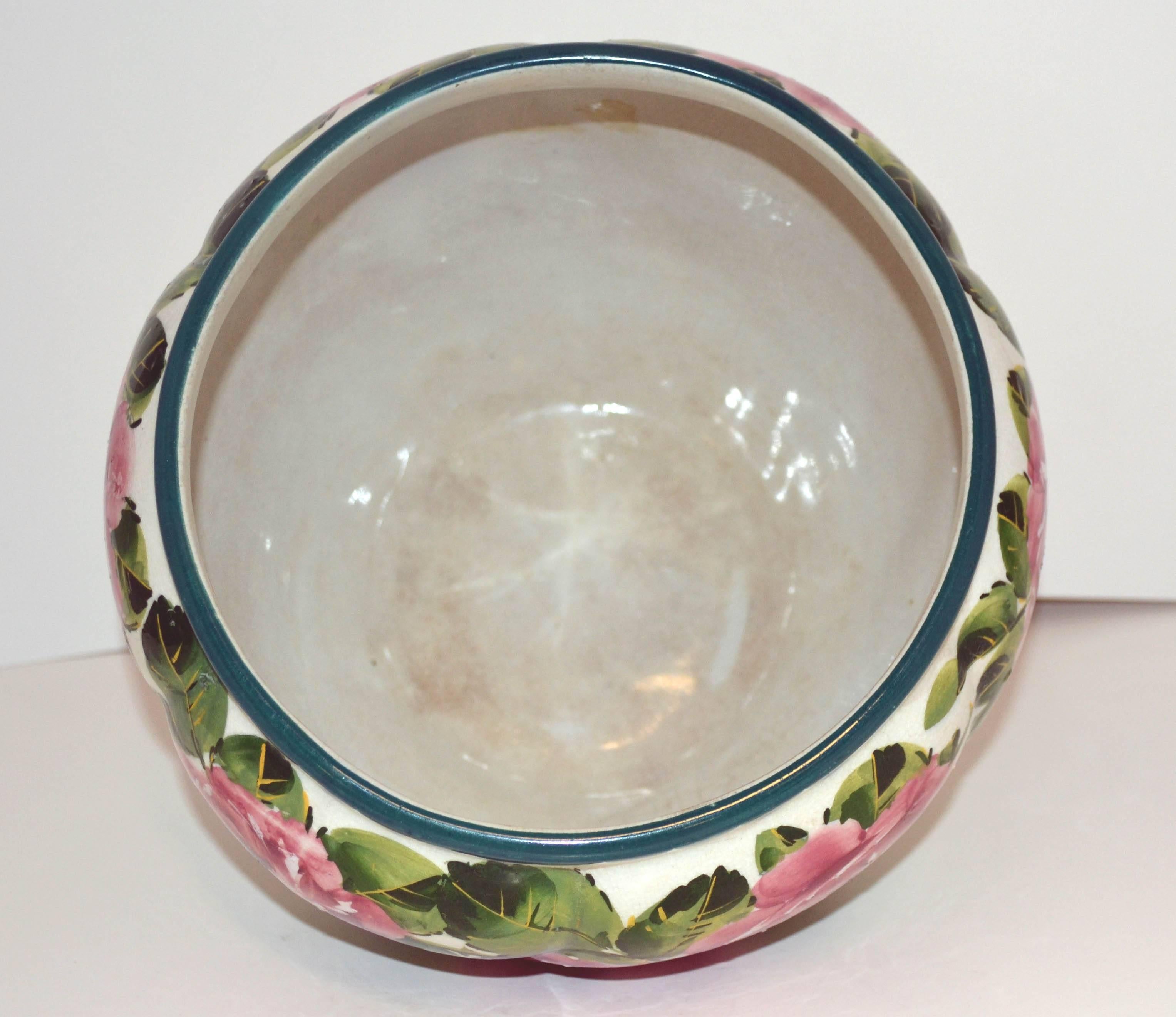 This beautiful late 19th century combe Jardinière is decorated in Wemyss's characteristic hand-painted cabbage roses and scalloped painted rim, circa 1880. Marked "Weymss" on bottom. Size is 6.75" H x 9.50" W.
One of several