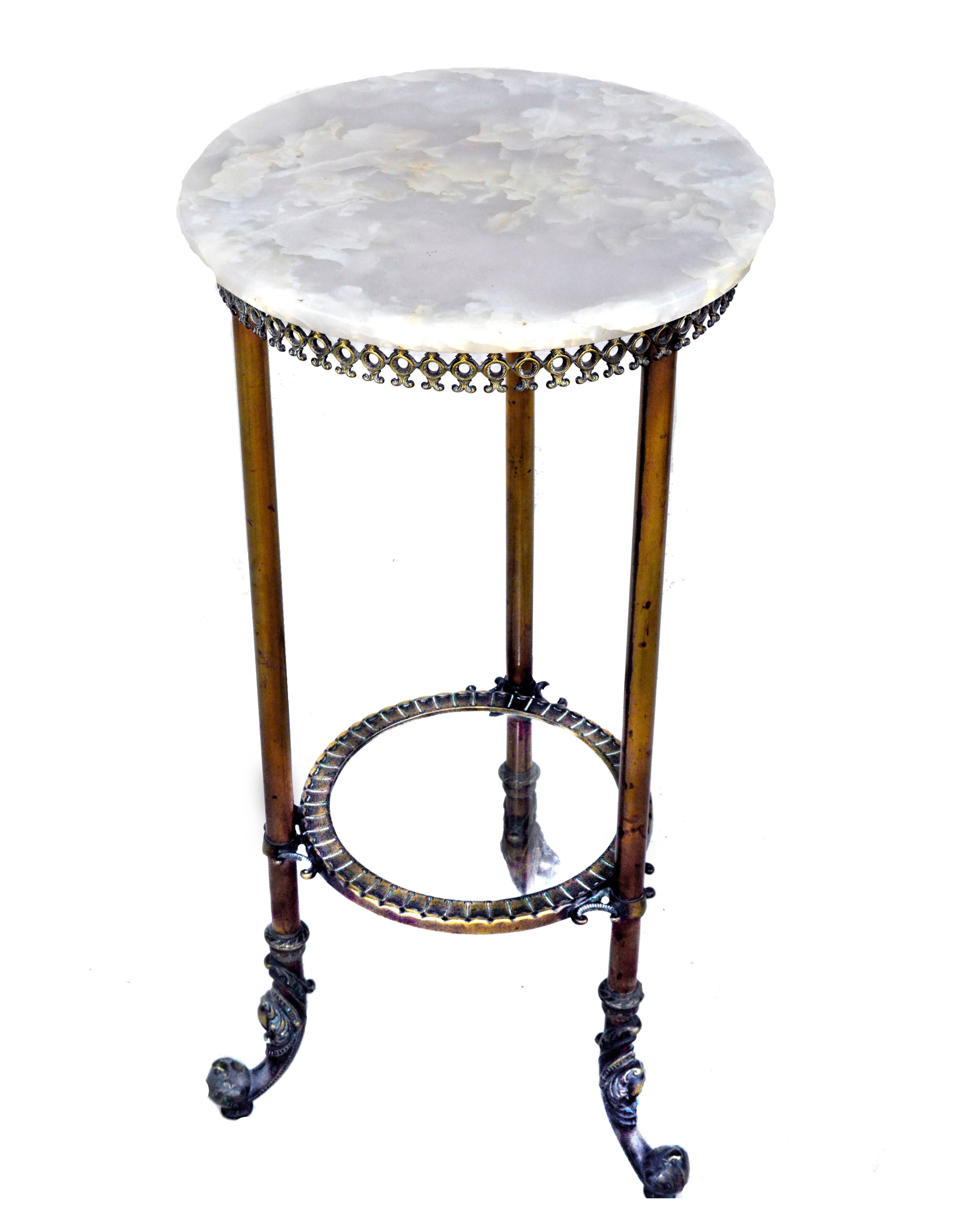 Three-legged marble and bronze table, round top. Round glass lower shelf, framed in bronze. Decorative feet. Measures: 31.5" H x 15" W x 15" D.